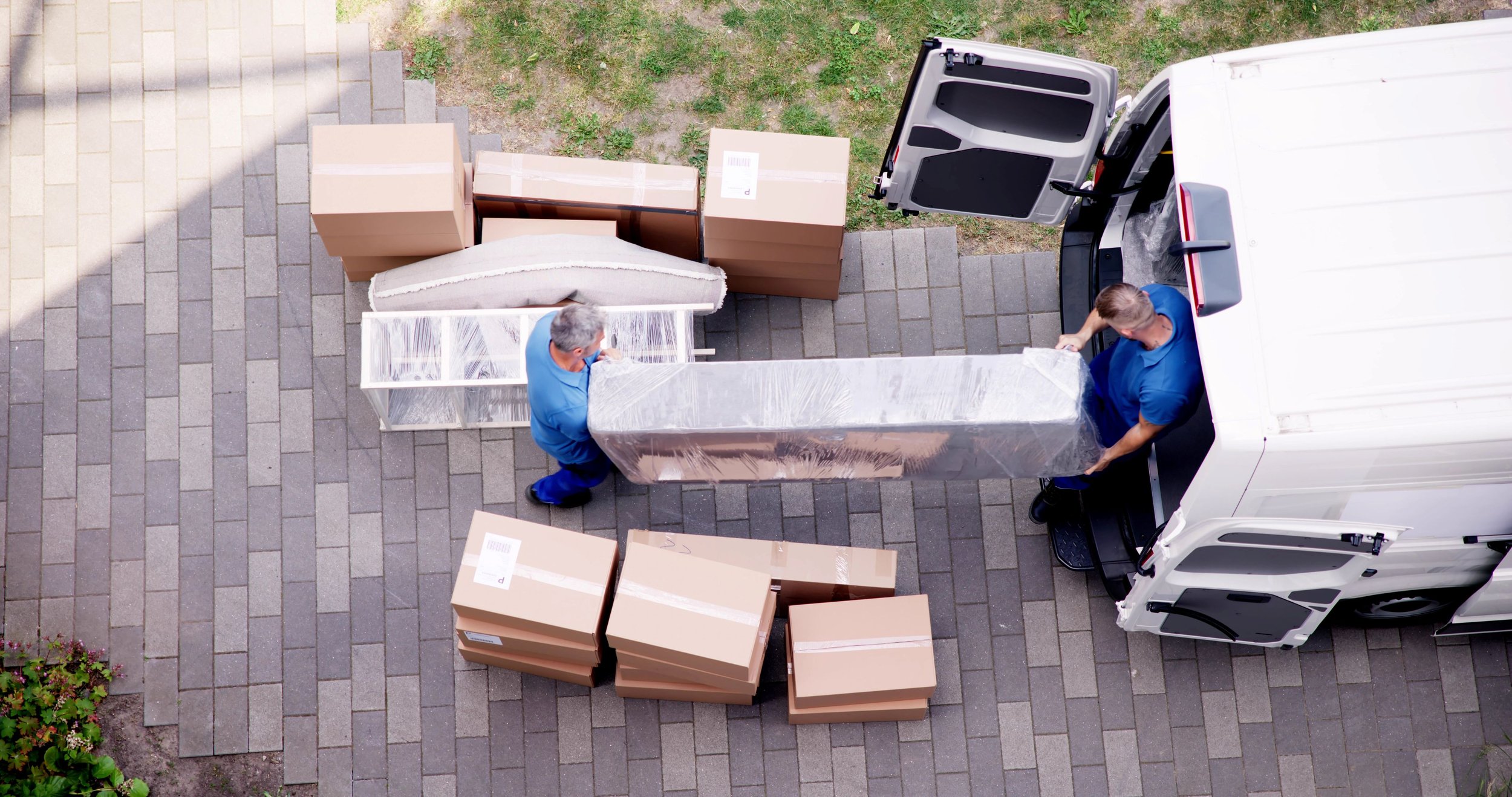 Movers loading a wrapped bookshelf for a Dallas concierge move