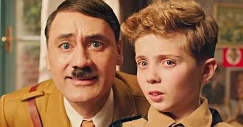 Jojo converses with his buffoonish imaginary depiction of Adolf Hitler, who replaces his missing father figure.