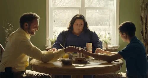 The Smith family praying before their meal.