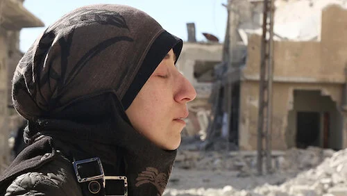 Amani Ballour taking in some solace amidst the destruction around her.