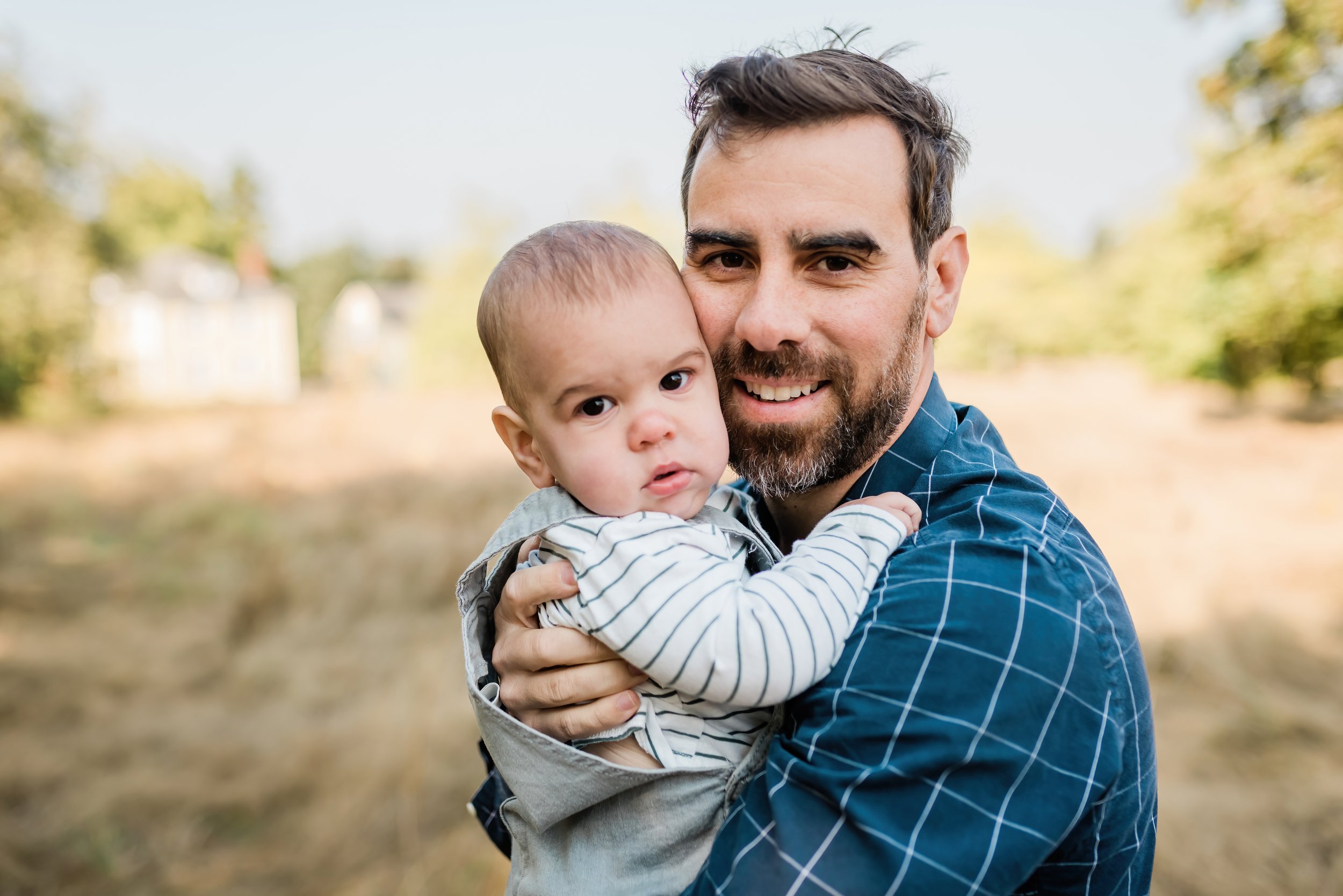  Dad snuggles his baby boy. 