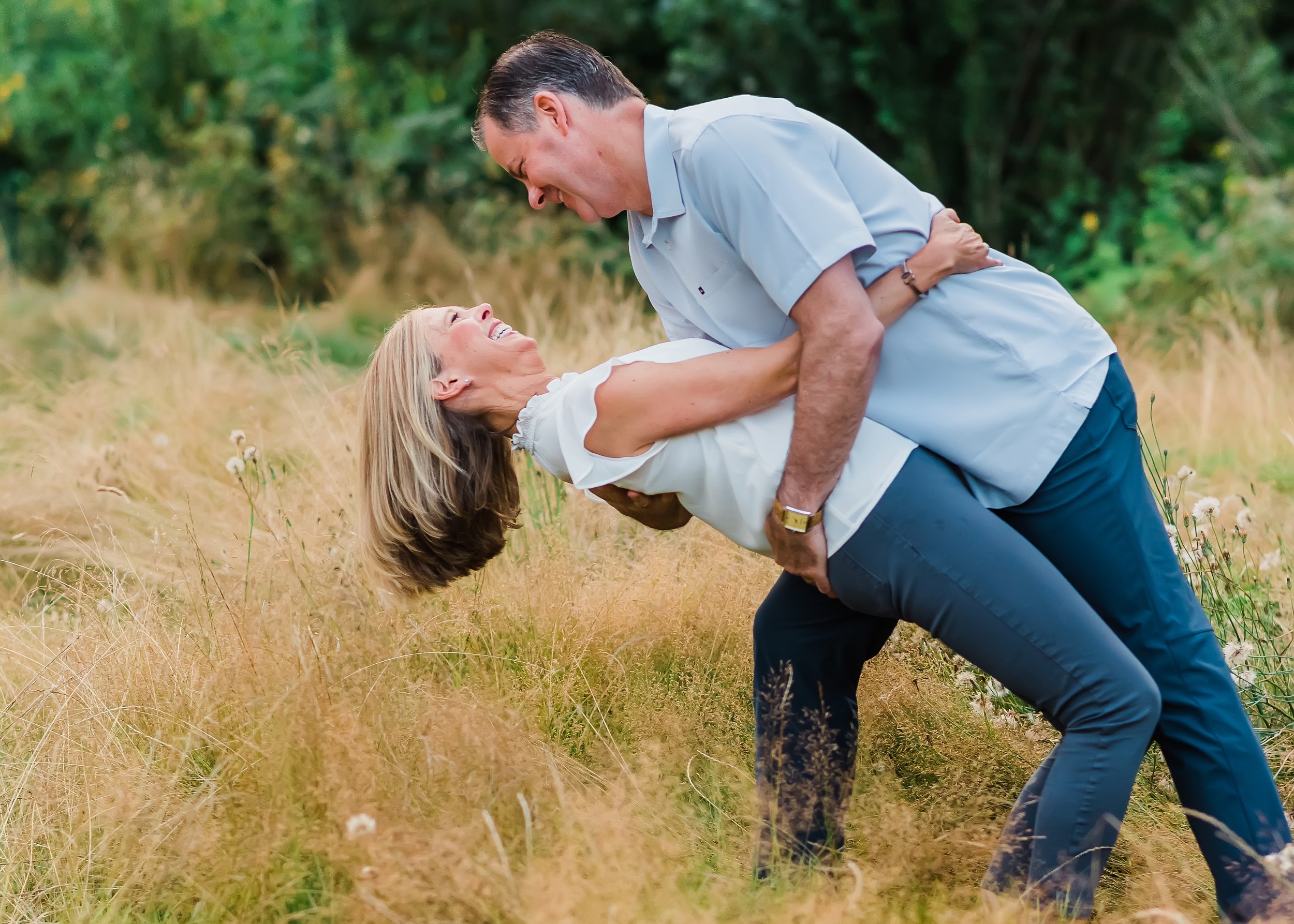  Husband dips his wife in a field. 