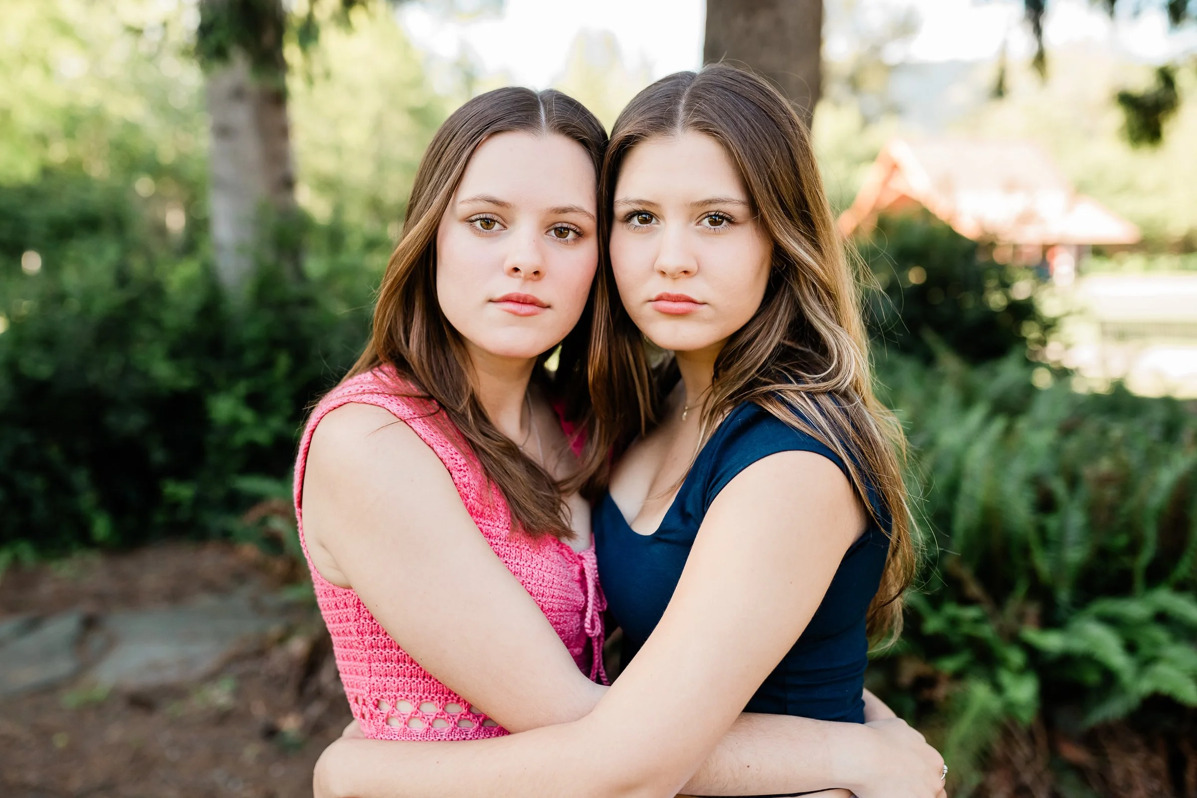  Sisters embrace and pose cheek to cheek at Confluence Park in Seattle WA. 