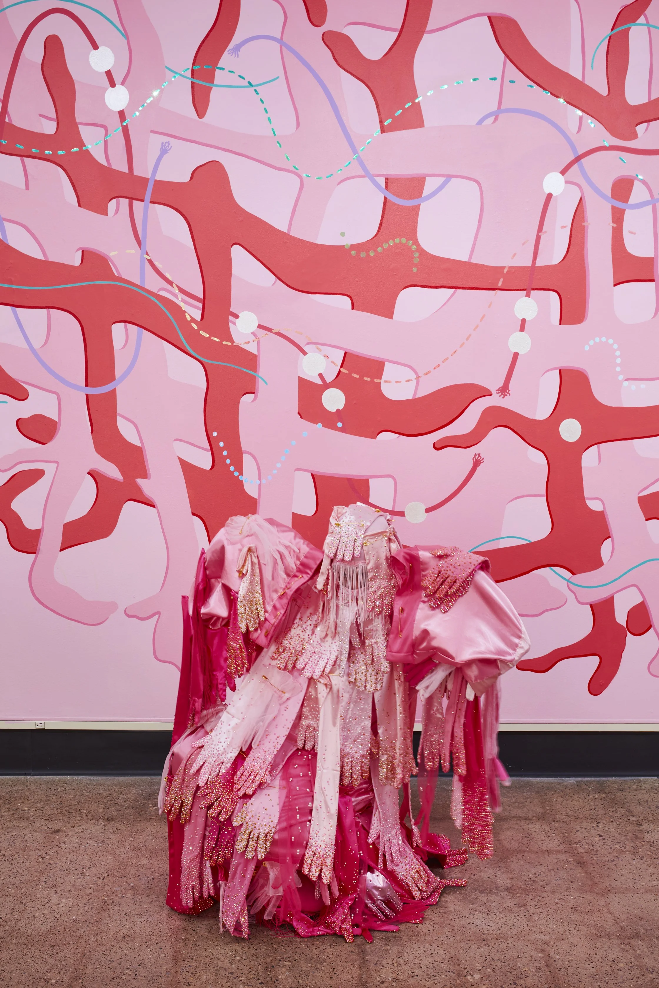   Hands Off! , 2025. Performative garment made from fabric, gloves, rhinestones, fringe, faux pearls, and oversized safety pins. 