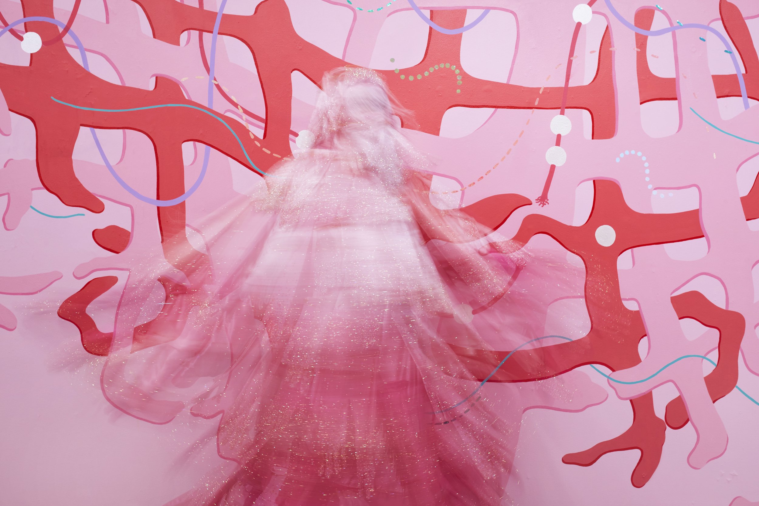   Hands Off!  (action), 2025. Performative garment made from fabric, gloves, rhinestones, fringe, faux pearls, and oversized safety pins. 