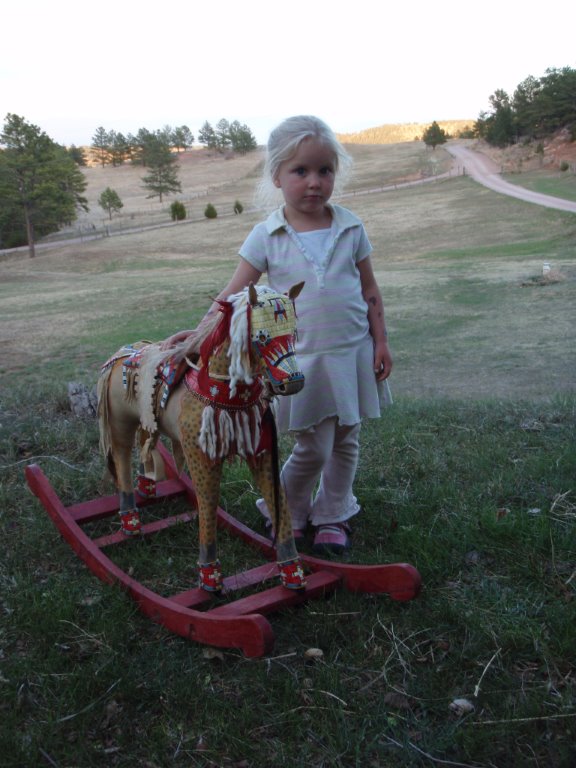 A model horse, complete with porcupine-quilled pad saddle, martingale, crupper and leg cuffs.
