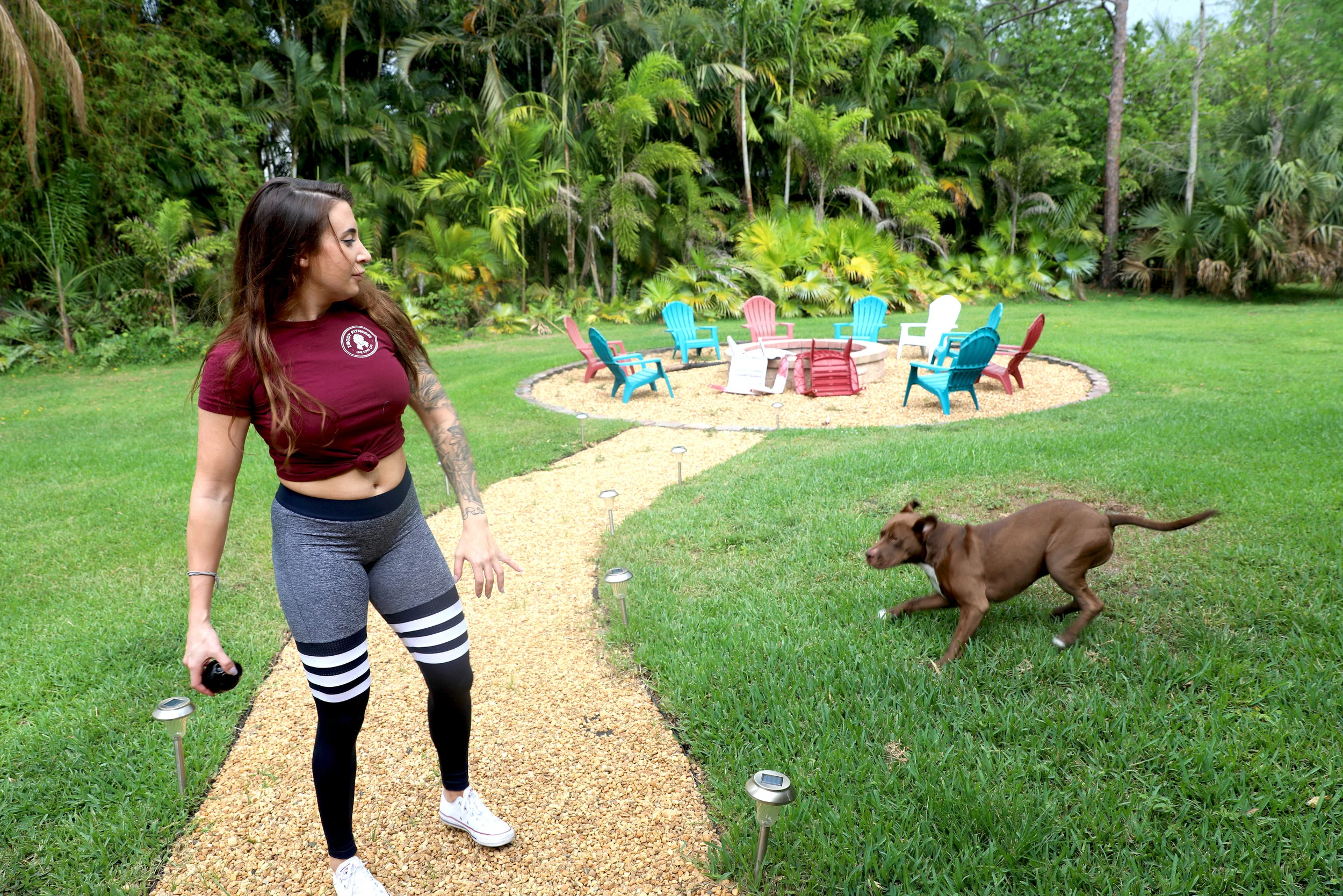  Rodriguez plays catch with her dog, Rocky,&nbsp;in the backyard right before a storm rolls in.&nbsp; 