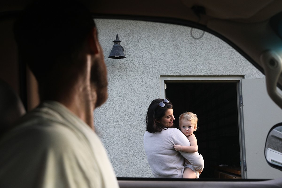  Clarkson stops his truck for a moment to greet his wife, Chelsea Clarkson, and their youngest daughter, Guinevere, as he does his morning chores around the family farm.  