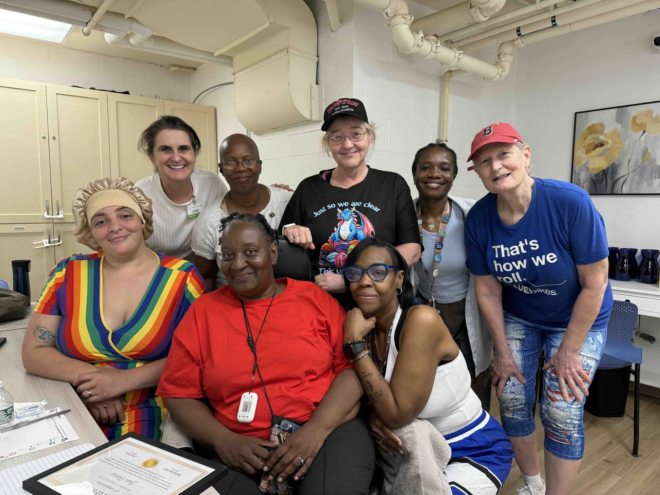 A group of women with certificates, graduating from the stabilization group at Women's Lunch Place.