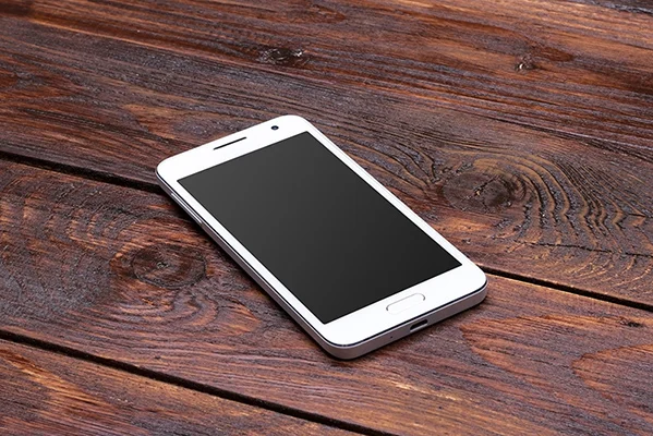 phone on wood desk 83769405.jpeg