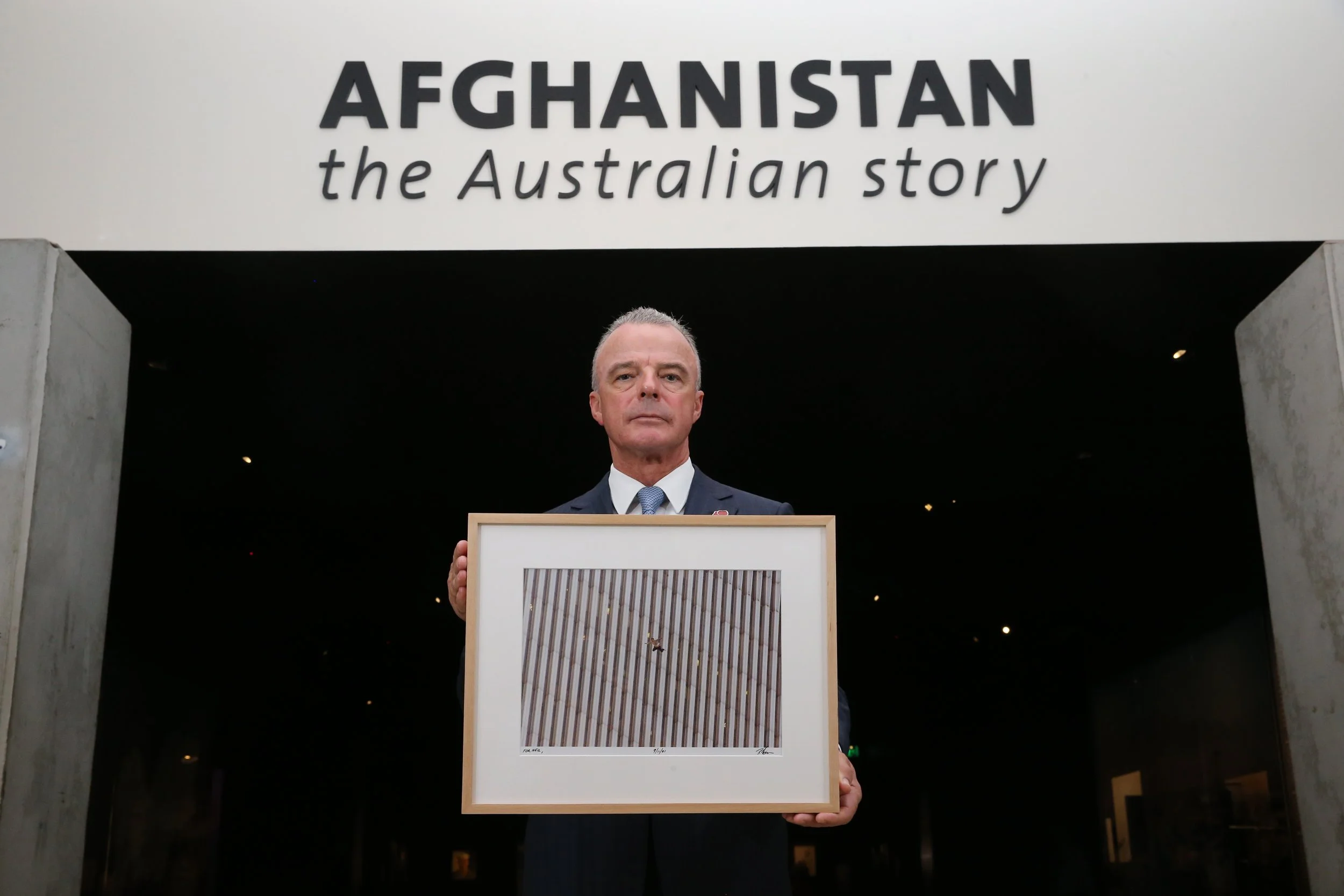 AWM director Brendan Nelson, with an image from AP photographer Richard Drew's sequence of "The Falling Man'' 