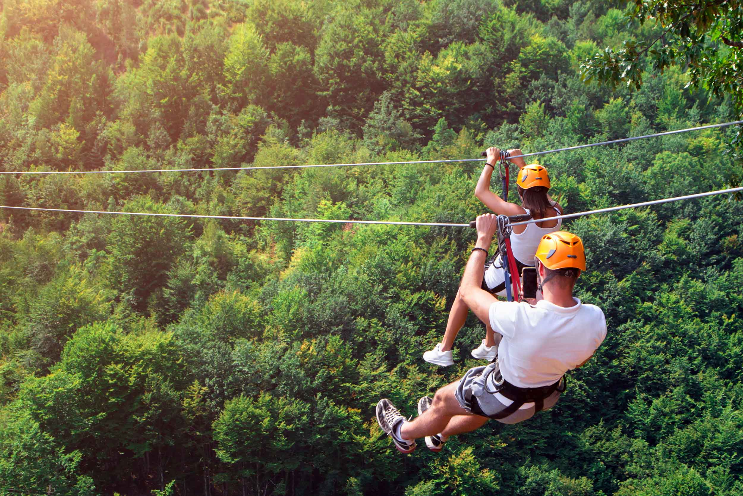 Man-And-Woman-Ziplining-Over-Trees.jpg