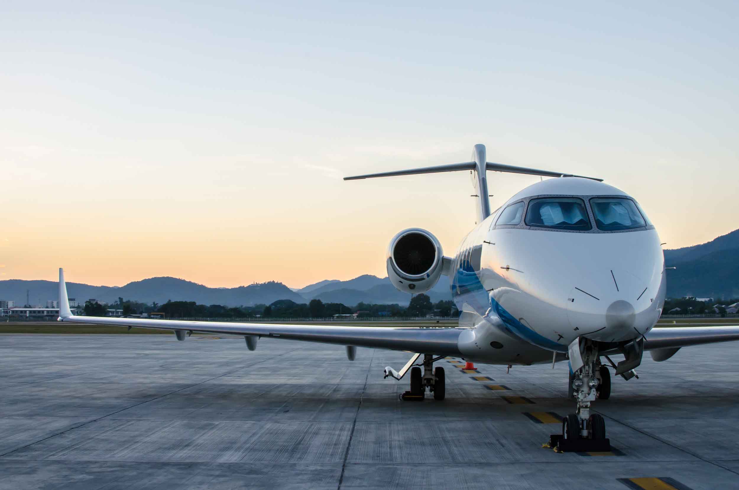Side-View-Of-Private-Jet-With-Mountain-Background.jpg