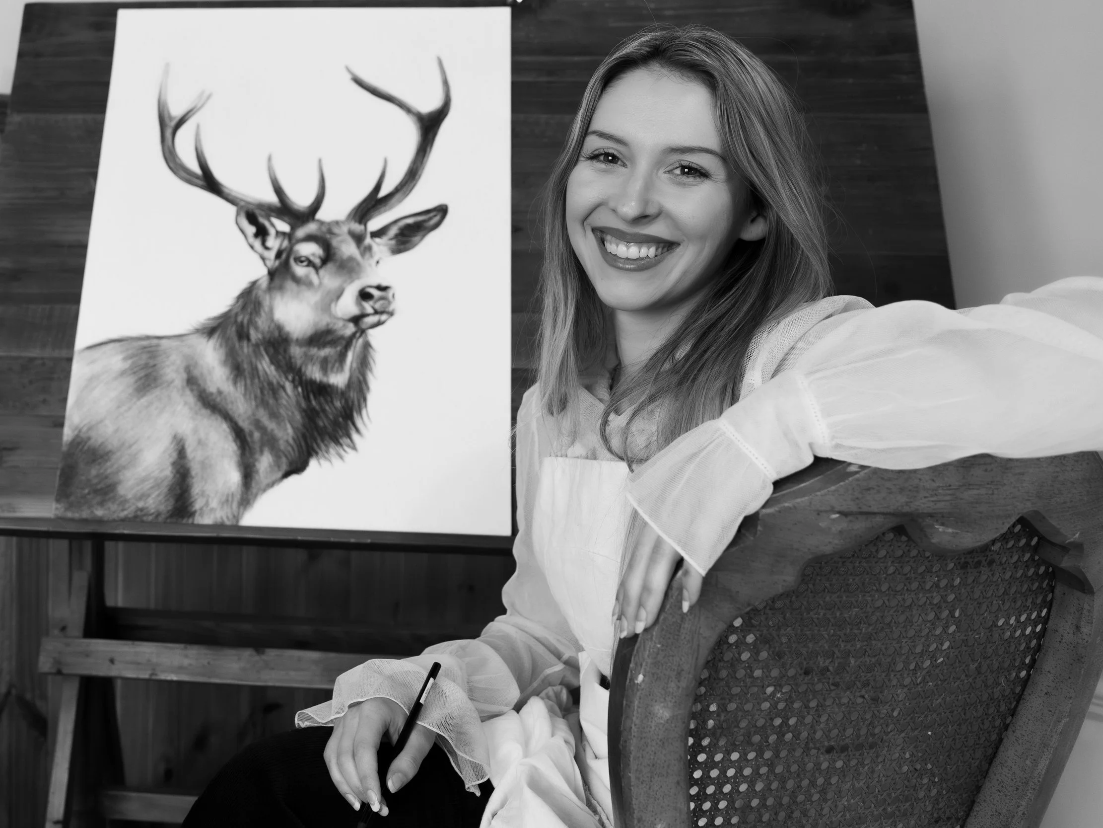 Tia Alysse with a student and her wildlife painting at a Country Canvases acrylic painting class