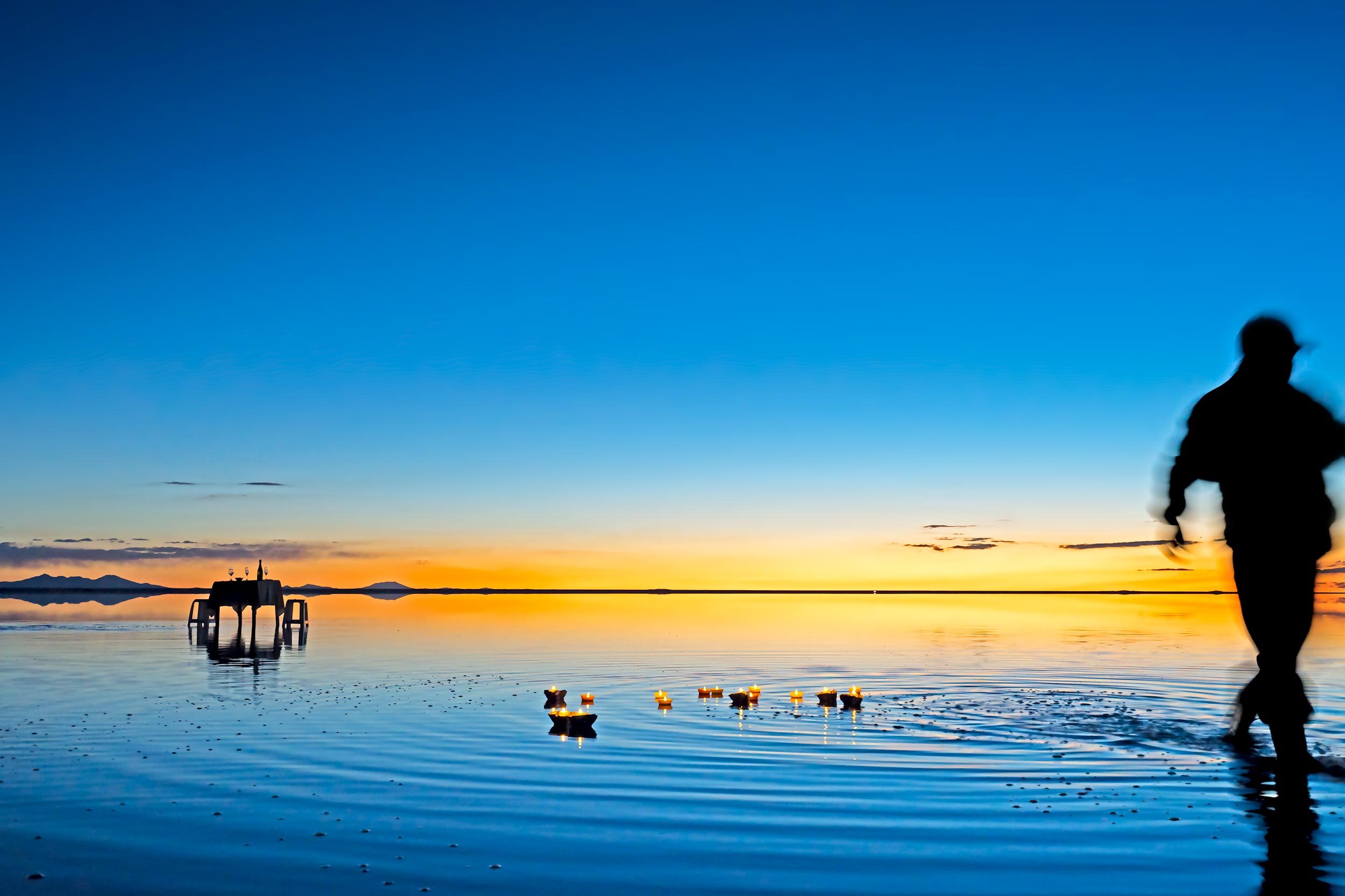 table-for-two-and-candles-on-flooded-salar-de-uyuni.jpg