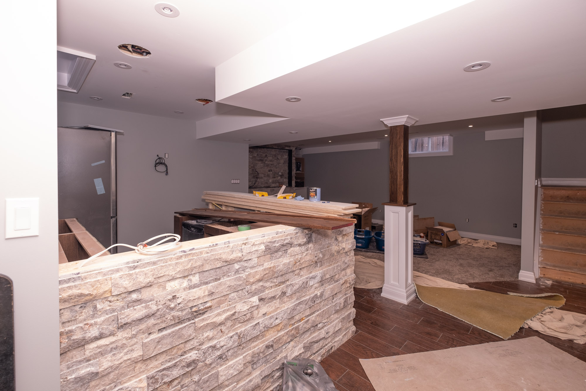 Stone bar with custom epoxy top in basement renovation in Acton