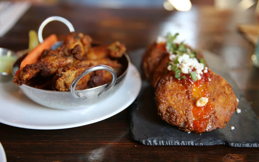 APPETIZERS: Smoked, crispy Texas Pete dry rubbed wings and fried green tomatoes, goat cheese, pepper jelly and basil