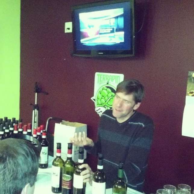 Jay Murrie pours several Italian wines for the patrons at Wine 101