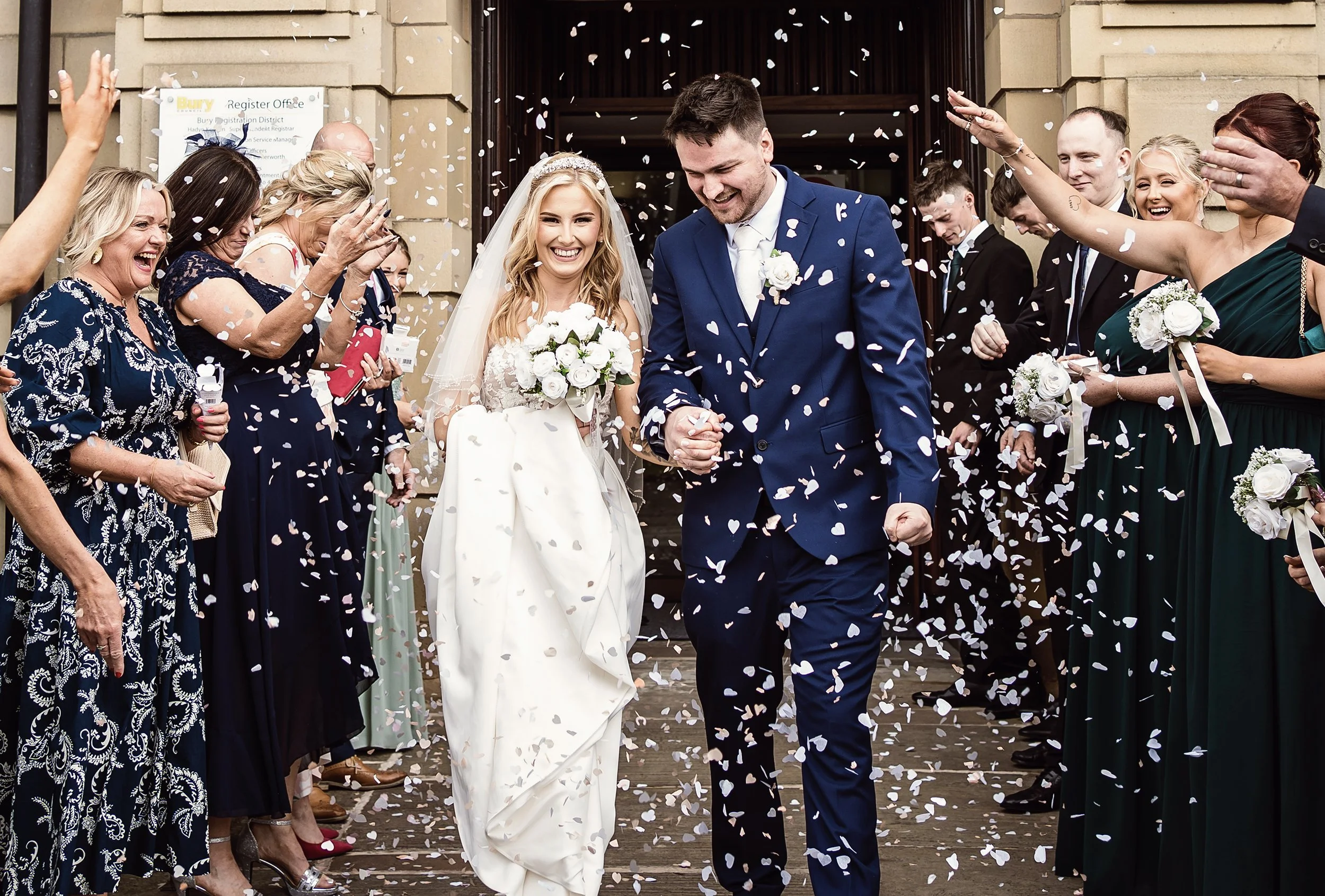 bride & groom during confetti throw at bury town hall