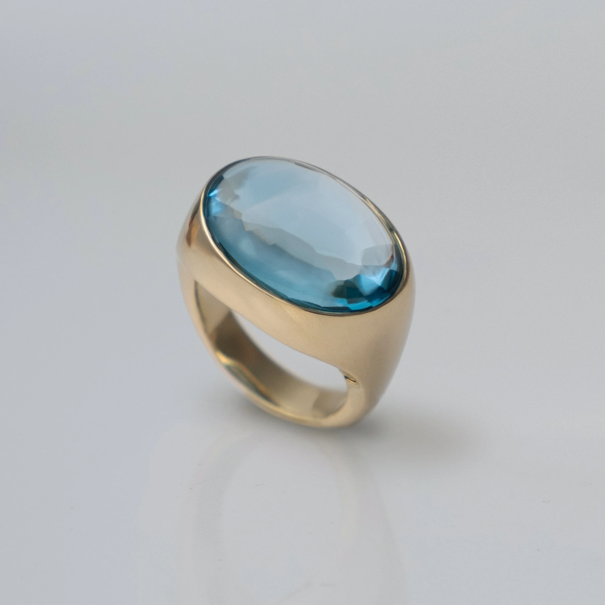 Cocktail ring in 9k gold with custom cut topaz, made by hand by goldsmith Julia Bocanet in Amsterdam.