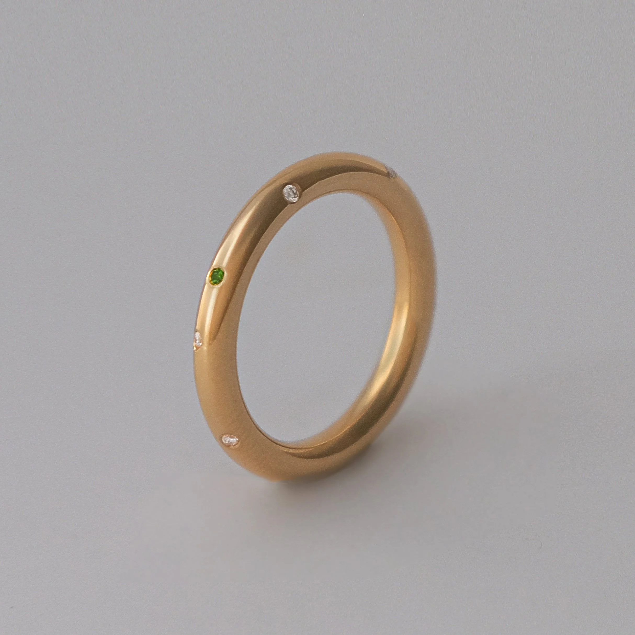 This bespoke gold ring is handcrafted by a goldsmith and set with tourmaline and diamonds. Designed as a meaningful first birthday gift, this luxury gold ring celebrates motherhood and marks a daughter’s first year with a timeless heirloom piece.