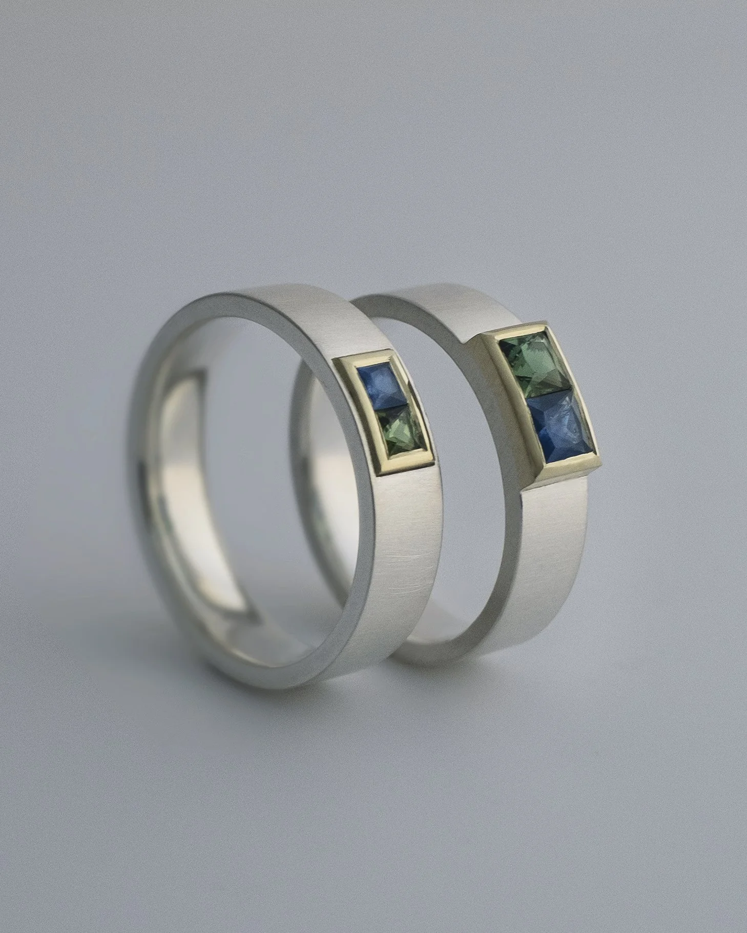 Wedding bands mixed silver and gold, with sapphire and tourmaline princess cut, made by hand by goldsmith Julia Bocanet in Amsterdam.