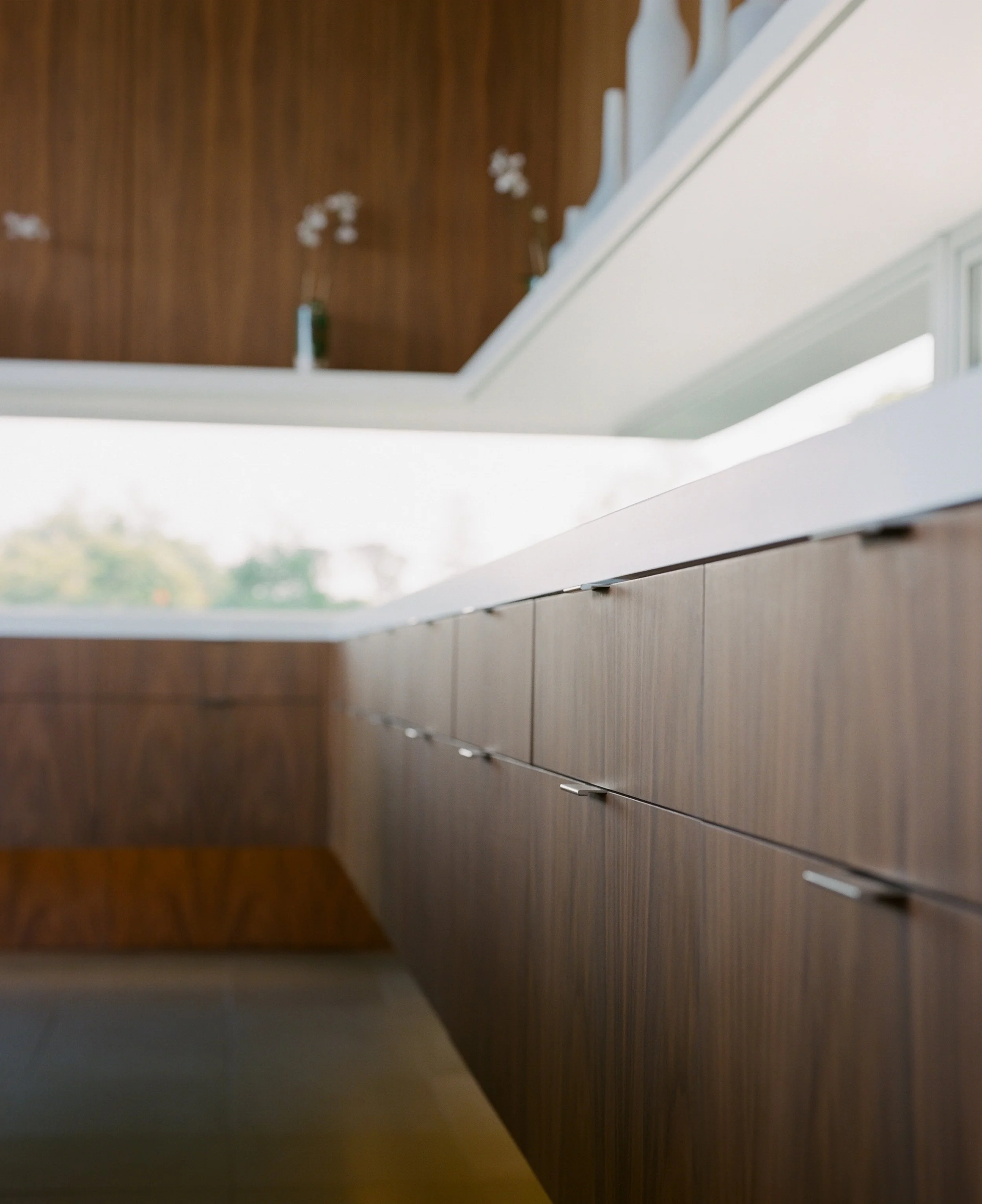  Select book-matched wall panels and cabinetry. Walnut wall panel flows through cabinetry face top to bottom. 