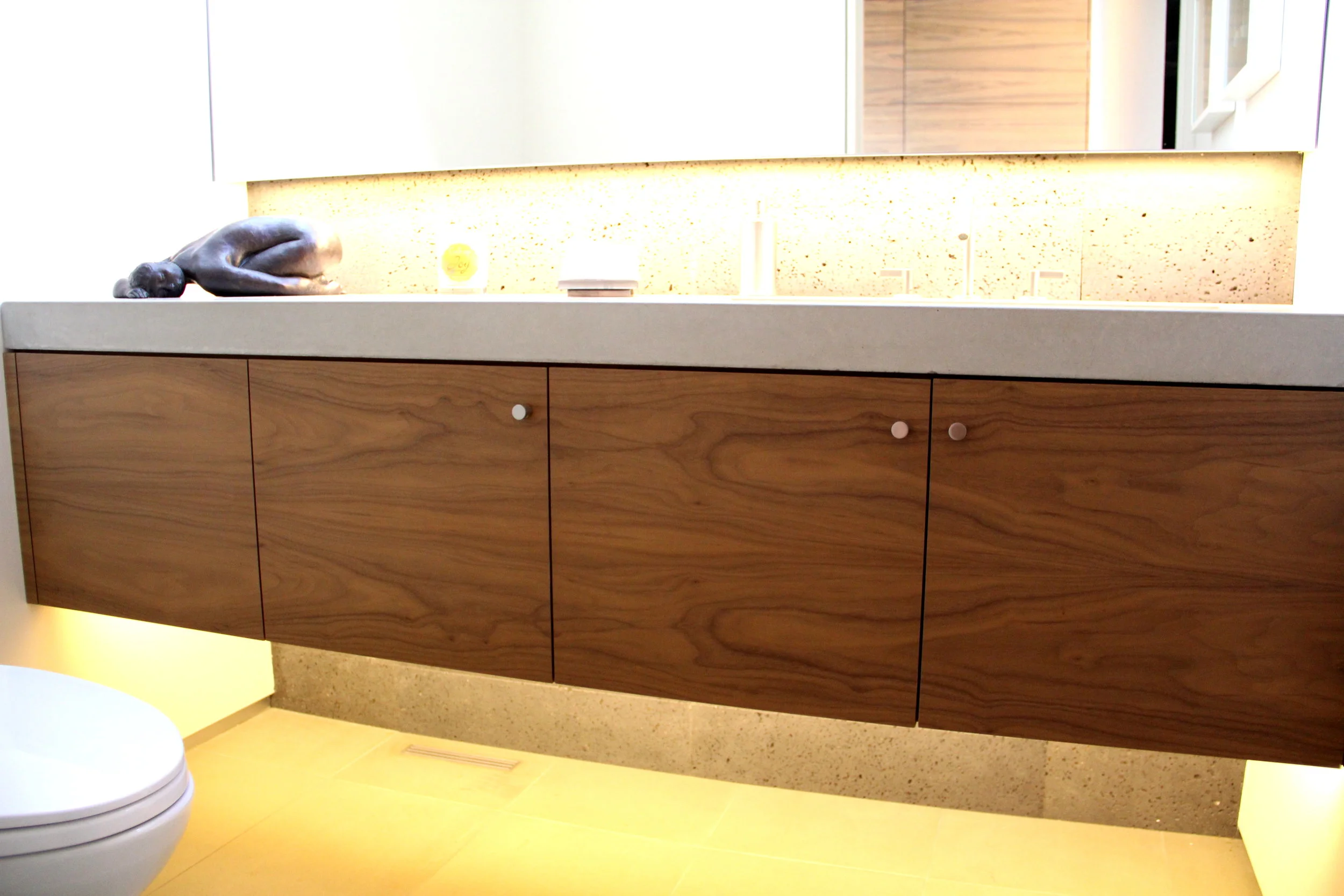  Select walnut floating powder bath vanity with horizontal grain book match. 