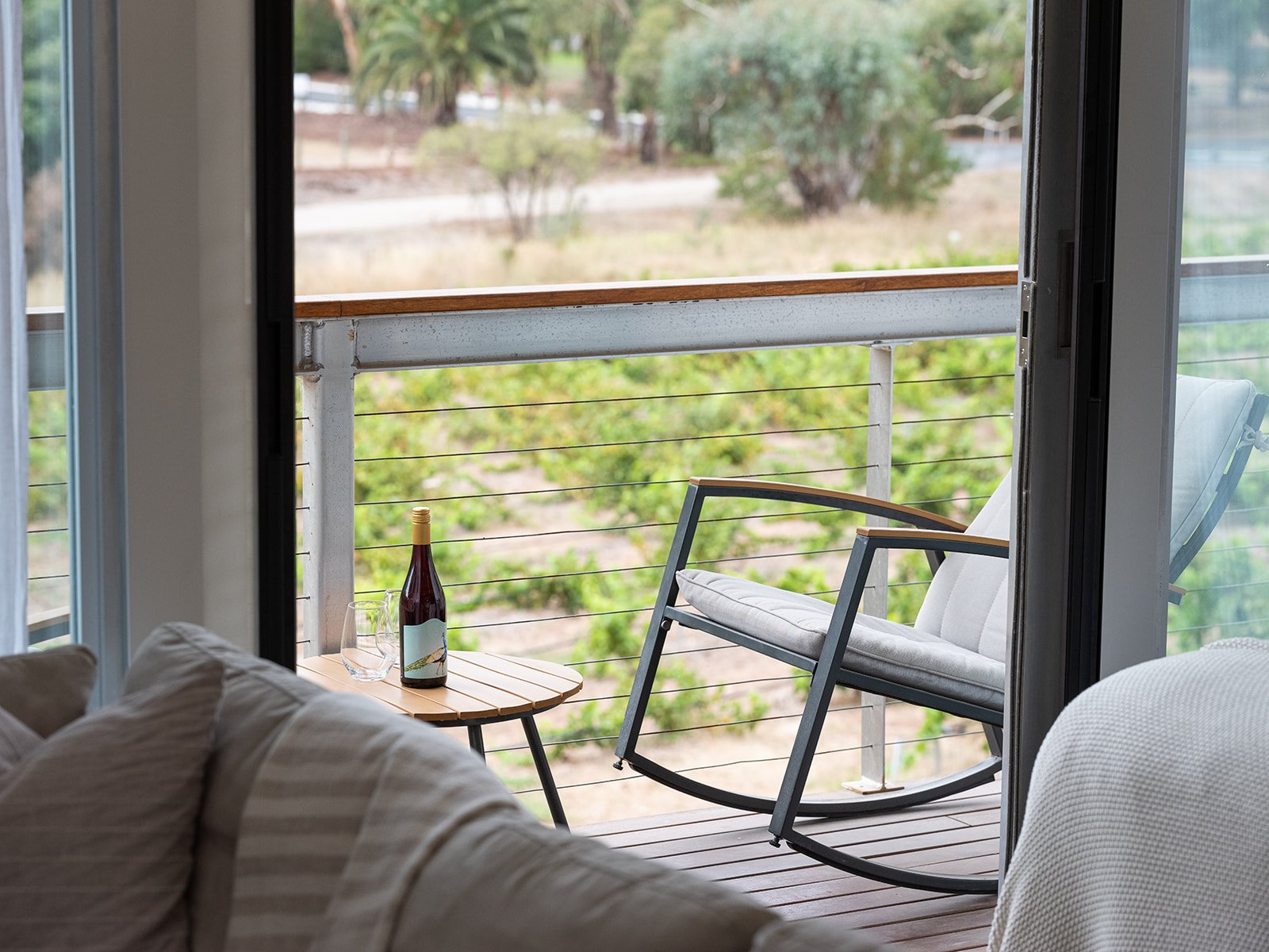 The Villas - Barossa vineyard accommodation, rocking chair on deck overlooking vineyard