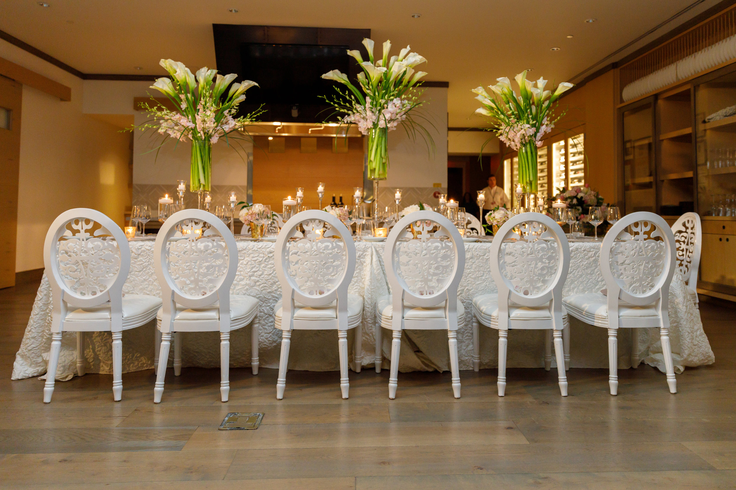 Elegant white, silver and blush table with candlelight, calla lilies and tulips for proposal