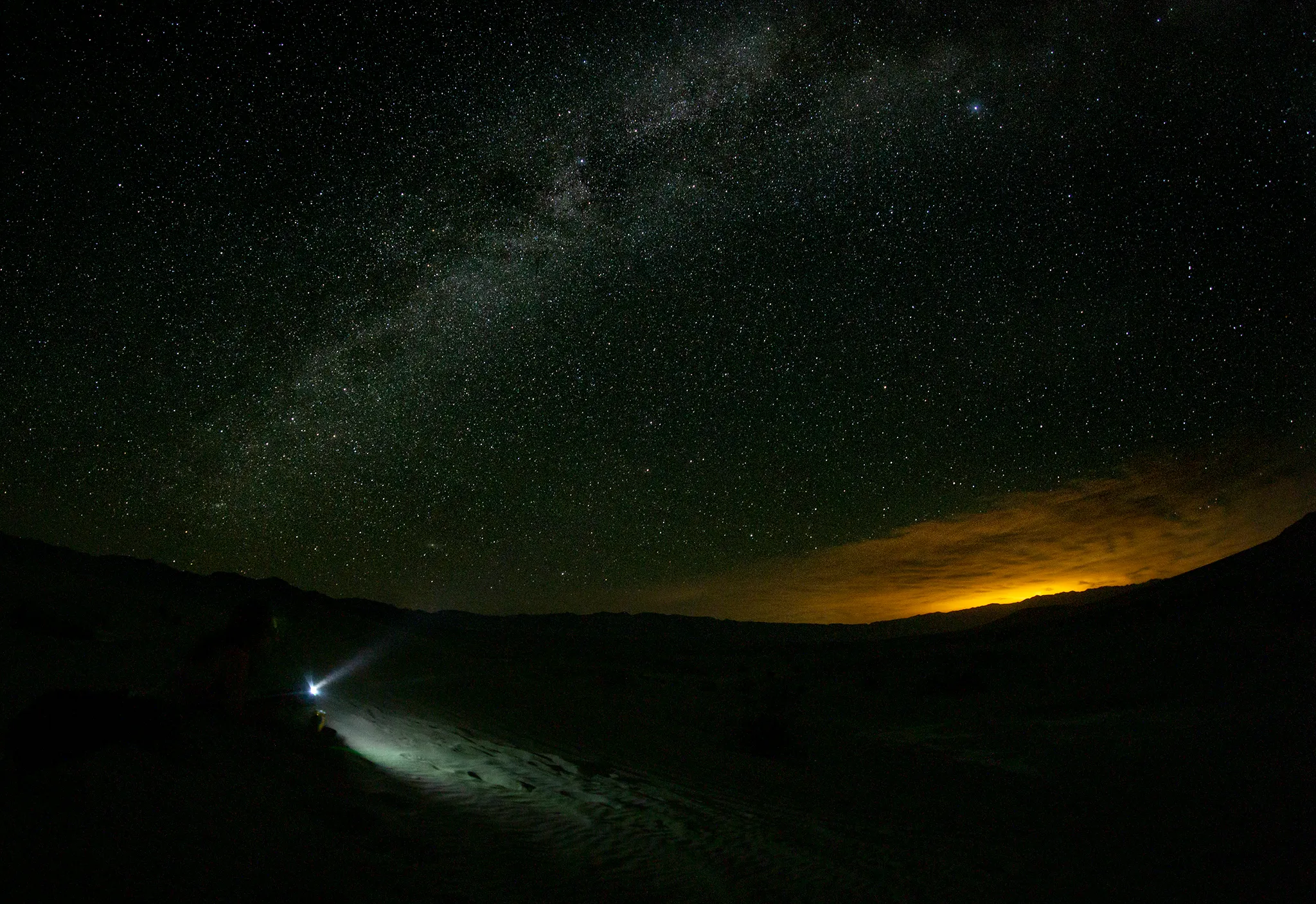 The Milky Way arcs over a night sky watcher | Peter Pearsall/USFWS