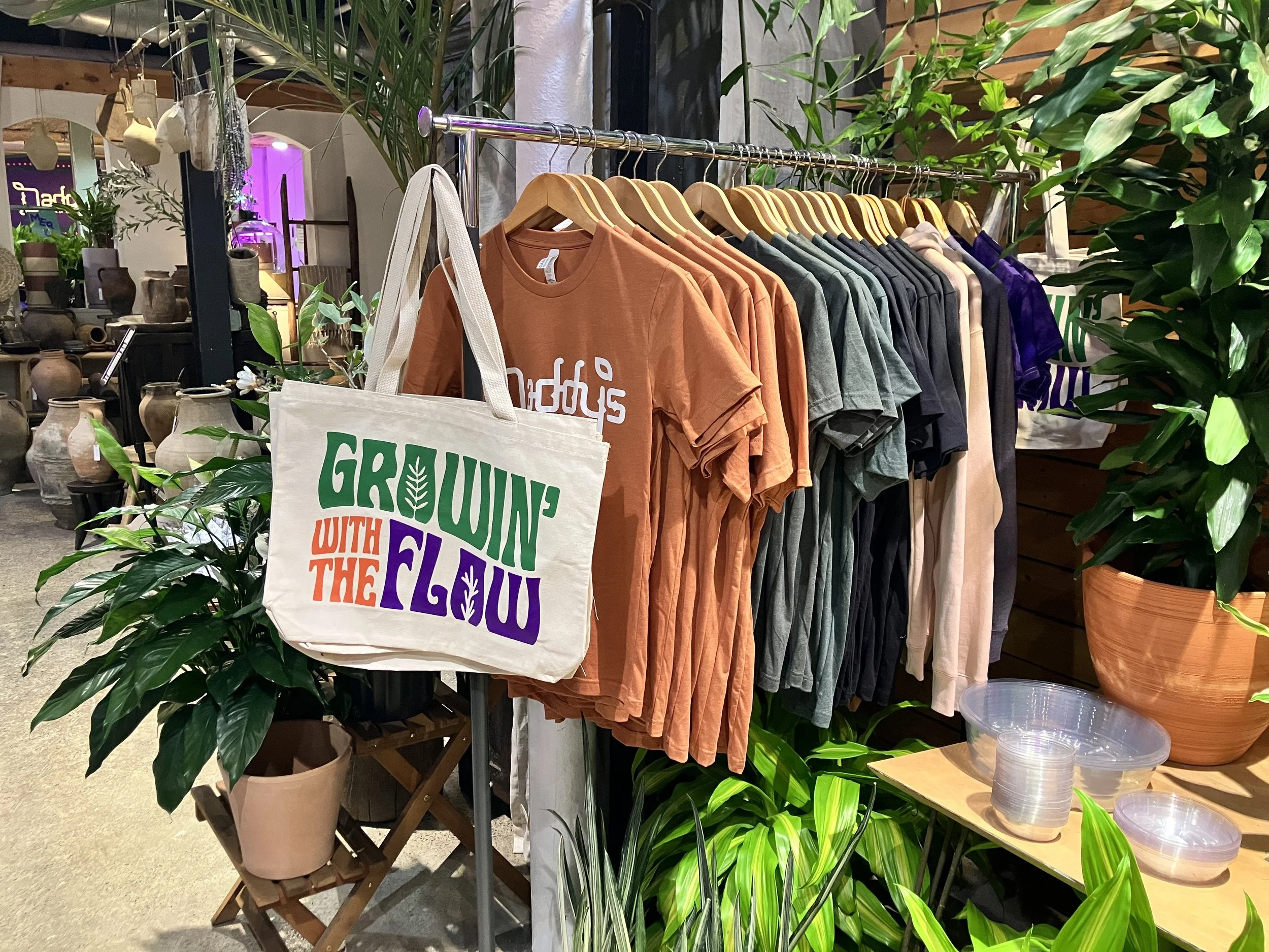 T-shirts, tote bags and sweatshirts featuring Daddy's Plants branding and original artwork