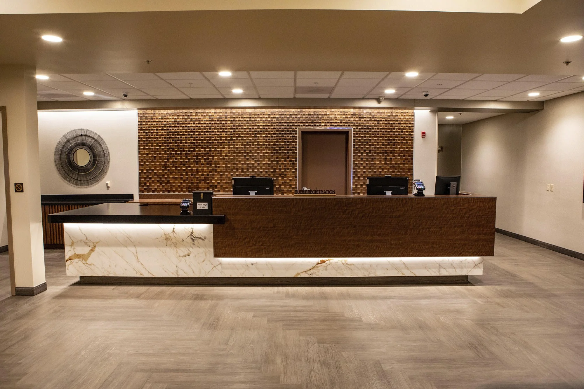 Custom check in desk emphasizing tribal textures and materials