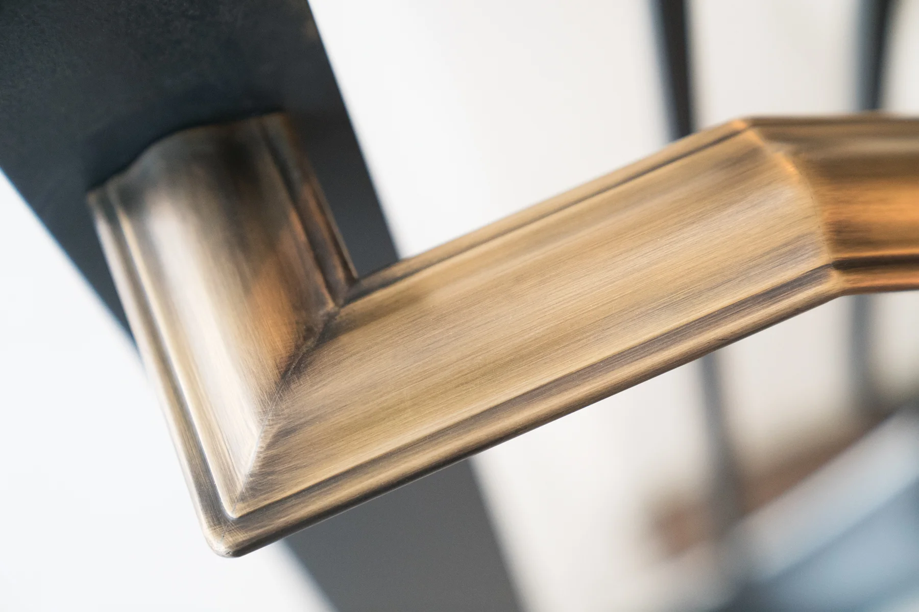 Patinated bronze cap rail detail from 4-story switchback stair with spiral transitions. Private Residence, Presidio Heights, San Francisco. ARCHITECT: Sutro Architects. CONTRACTOR: Upscale Construction. PHOTO: Jenn Chan