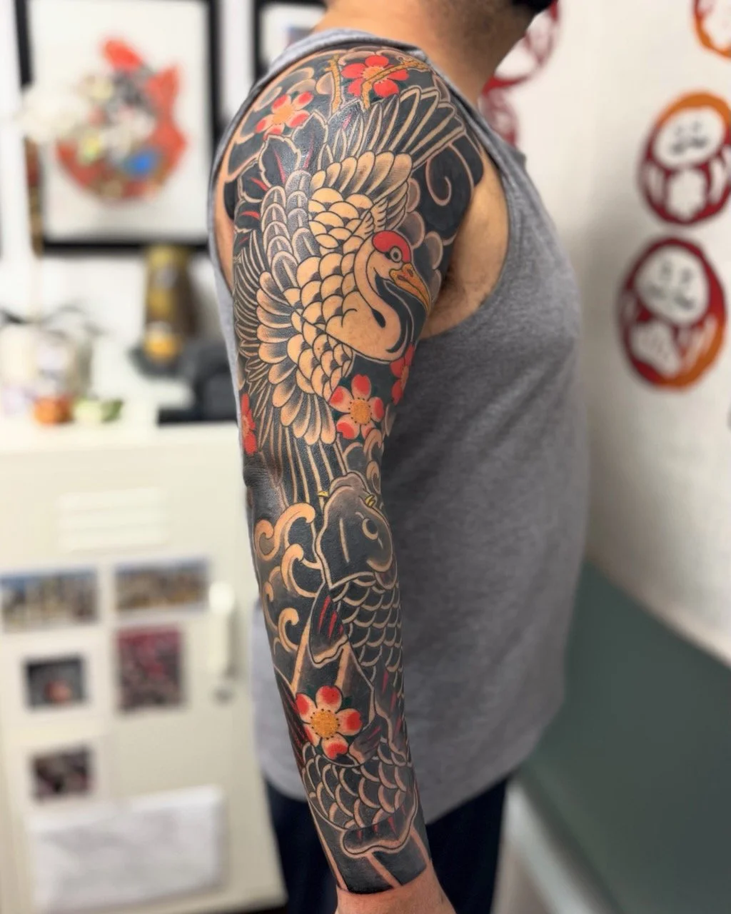 Japanese Irezumi full sleeve featuring crane, koi, sakura, water and wind