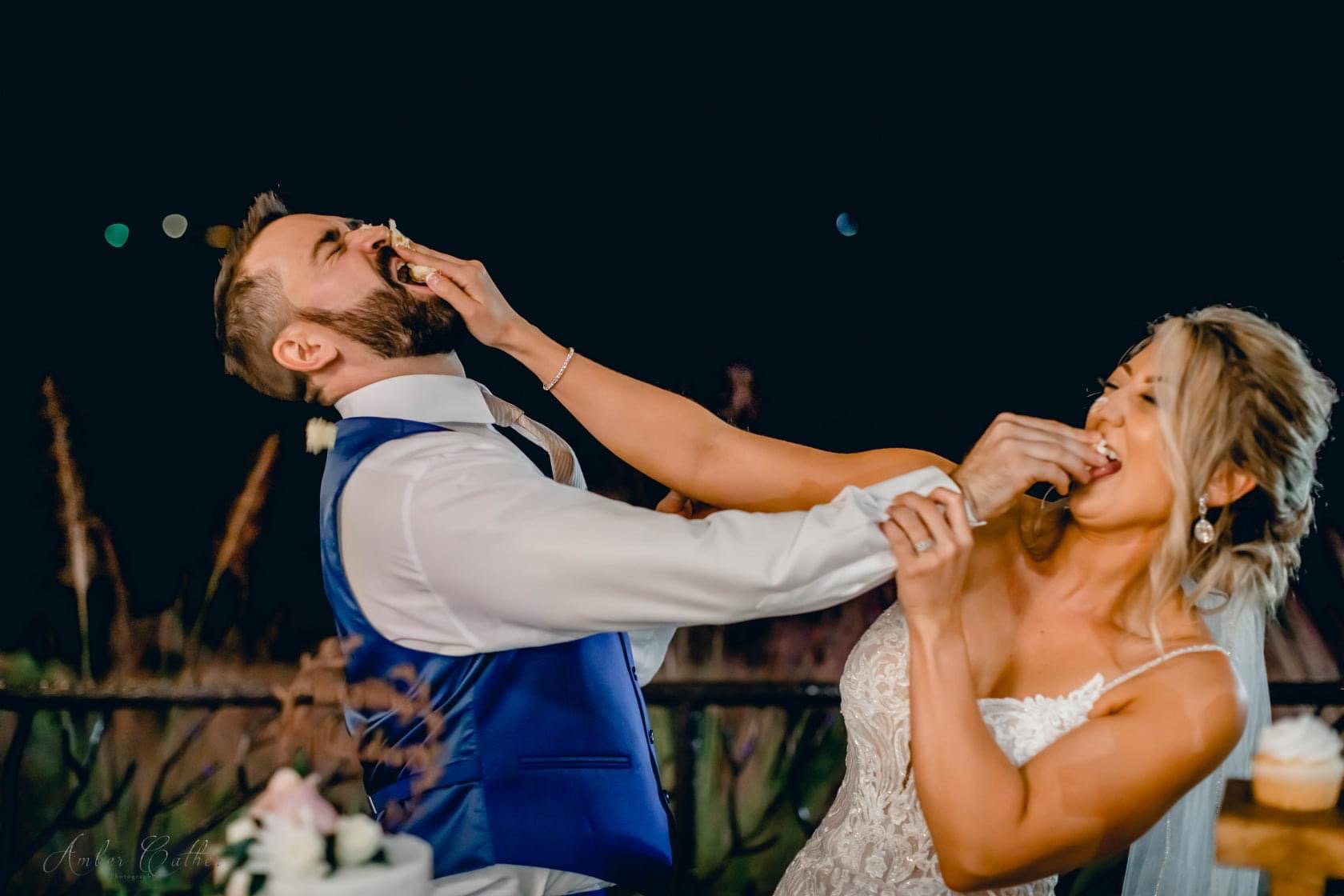 bride and groom shoving cake in the face .JPG