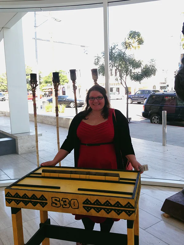 Christina-LeBlanc-with-challenge-table-and-torches-from-Survivor-at-Survivor-15th-anniversary-exhibit-at-Paley-Center-photo-by-Live-the-Movies.jpg