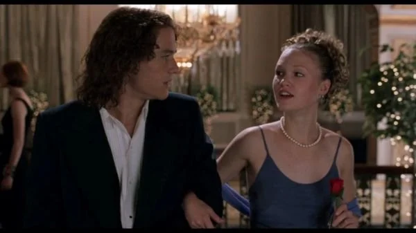 Heath Ledger as Patrick and Julia Stiles as Kat link arms and walk into the prom. This scene from 10 Things I Hate About You was filmed in the lobby of the Paramount Theatre in Seattle, Washington.