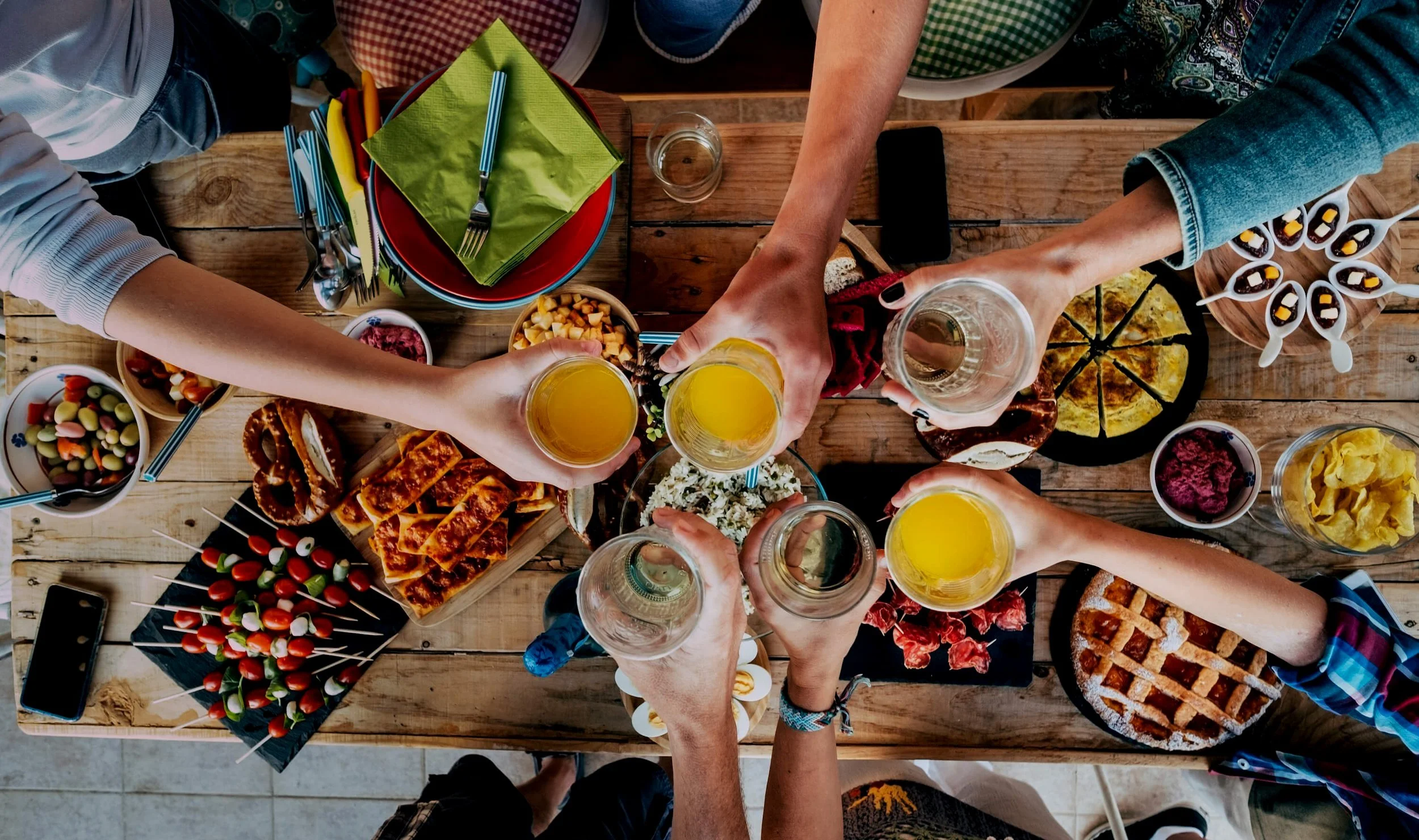 table-with-food-and-friends-clinking-and-toasting-2021-08-29-16-38-47-utc+%281%29.jpg