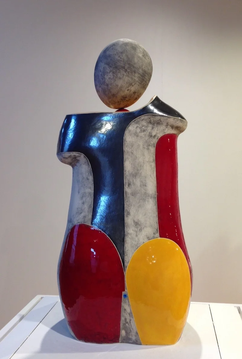  CHEEKS - Ceramic with multiple glazes - 27” x 13” x 11”   One of the distinguishing characteristics of my abstract figurative sculpture is that most do not have a back,  instead there are two different yet related fronts. Her name reflects this dist