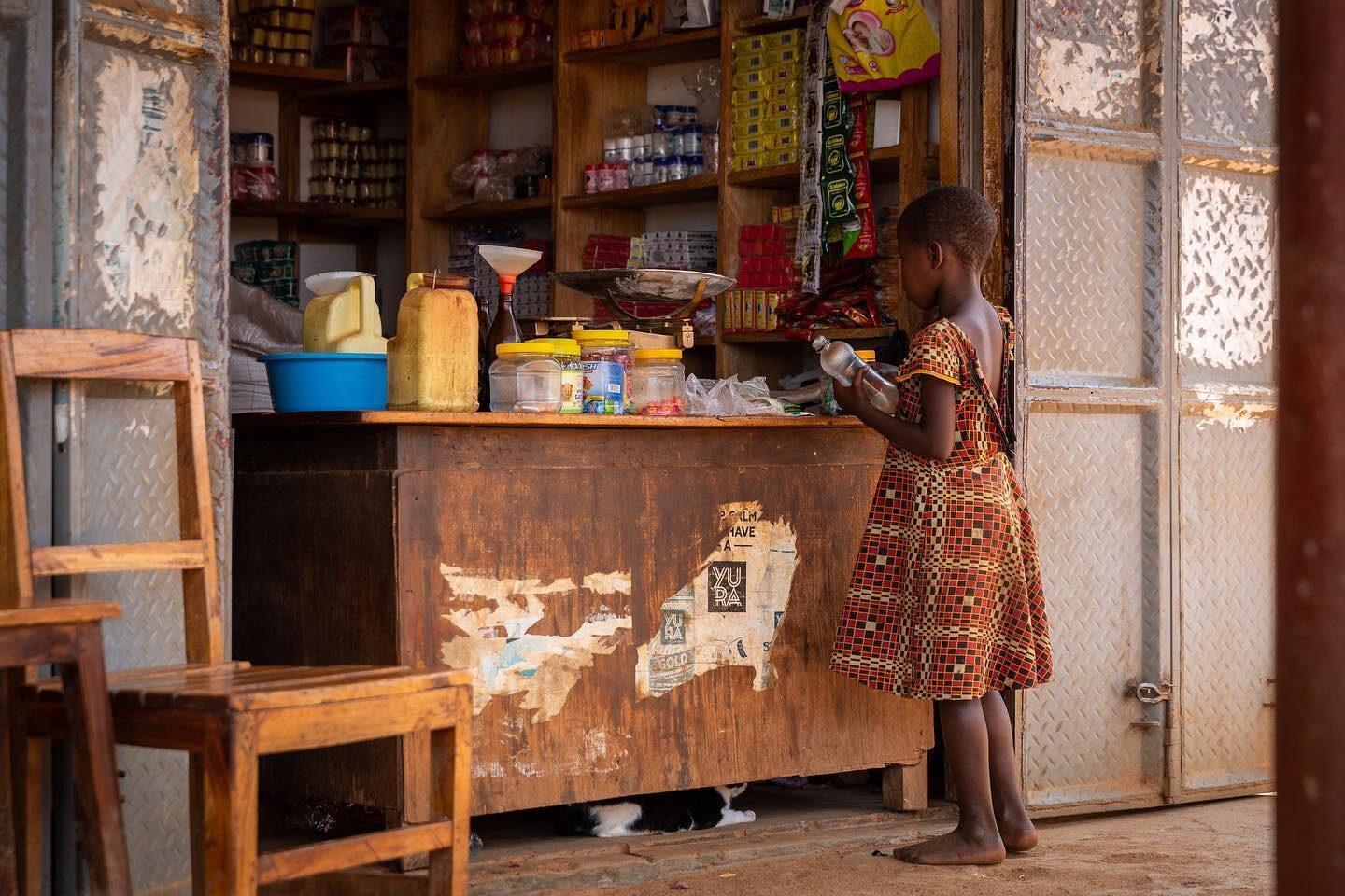 This young girl was buying oil from a local shop. She brought her own containers and the the shop keeper filled them from his stock, using funnels to avoid spills.
.
.
.
#musolivillage #mayuge #uganda