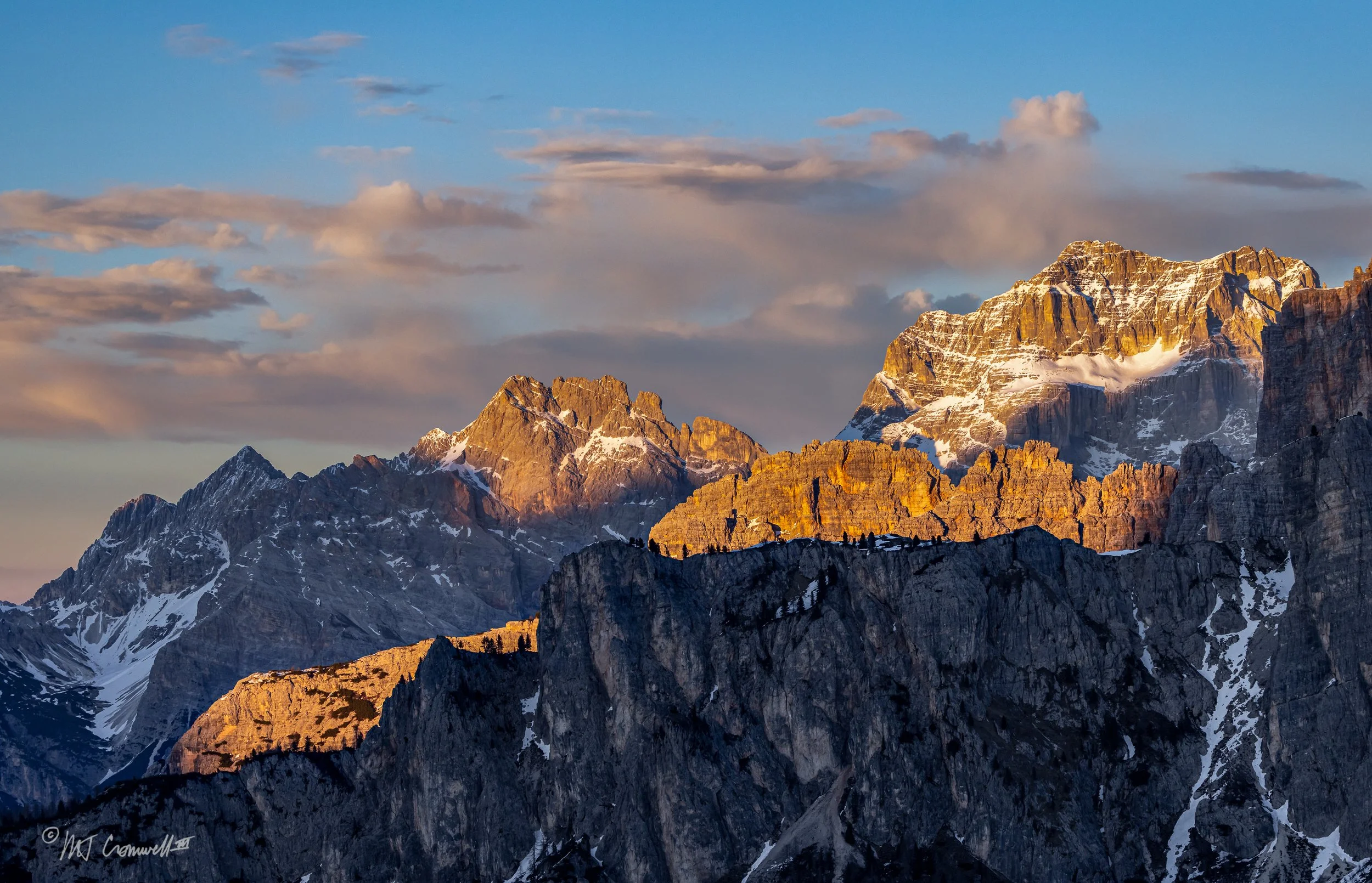 Sunset Silhouettes of Pine Trees on Top of Ridge in Dolomites