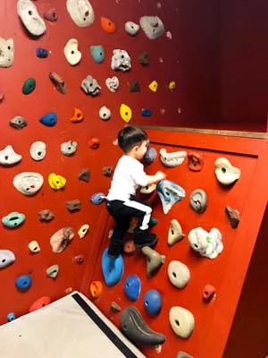 The rock climbing wall is a place where kids can challenge themselves and burn off pent-up energy.