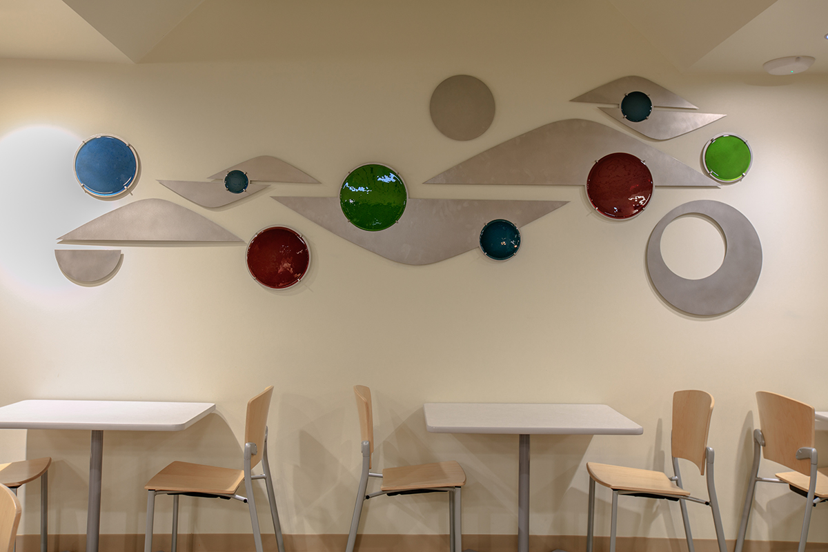 I also designed a unique aluminum and glass wall sculpture inspired by the metal art pieces found in the hospital’s main entry and lobby which were designed by the late Brother Mel Meyer. Using colorful graphics and custom designed art pieces, our team created a warm, comforting space that enhances the guest experience and connects visitors with SSM’s mission and history.