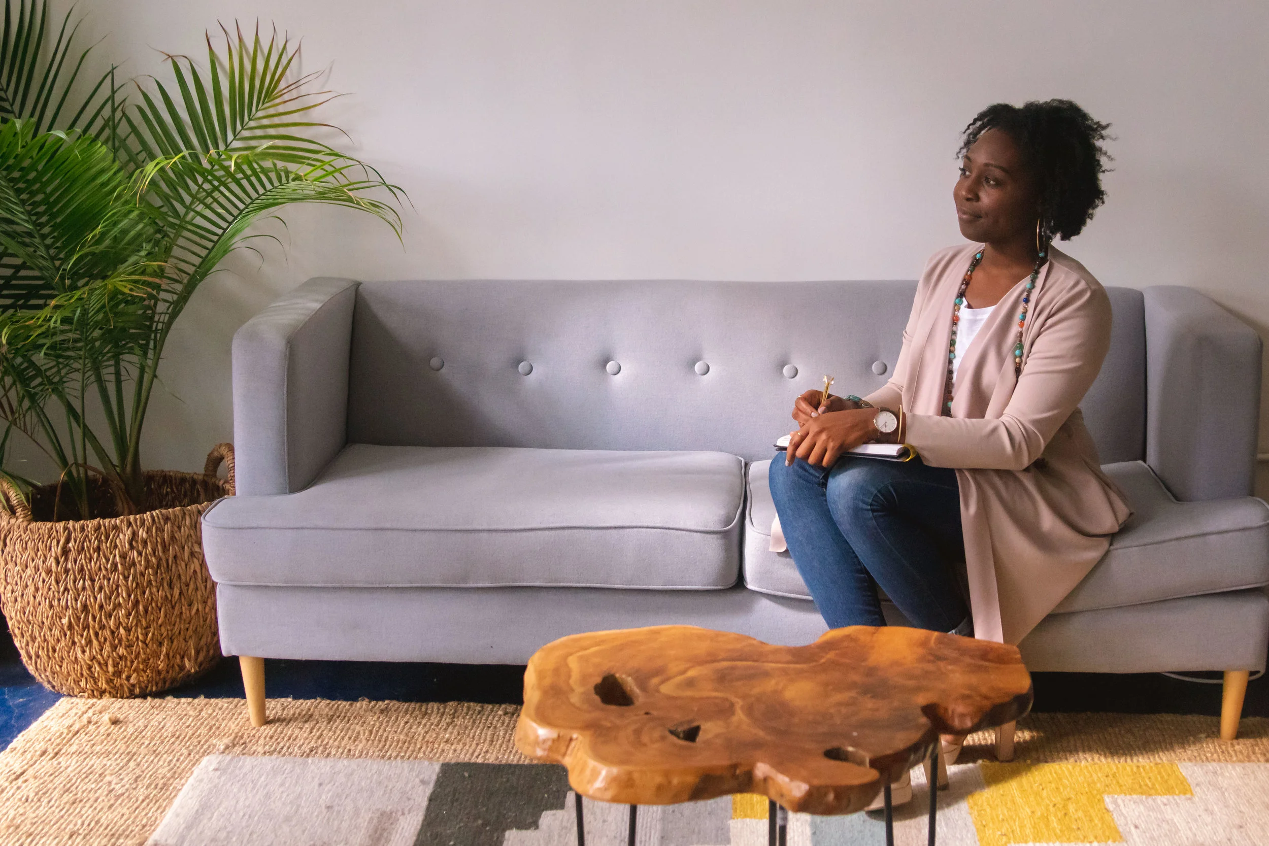 Woman sitting on couch looking out of window