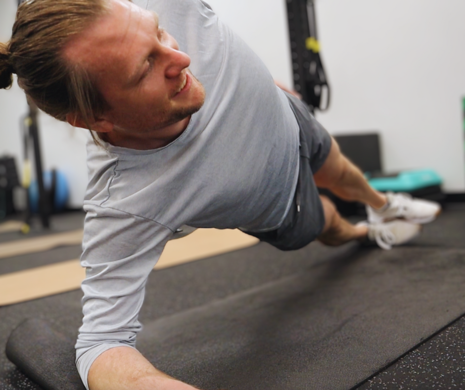 Man performing a side plank during a personal training workout