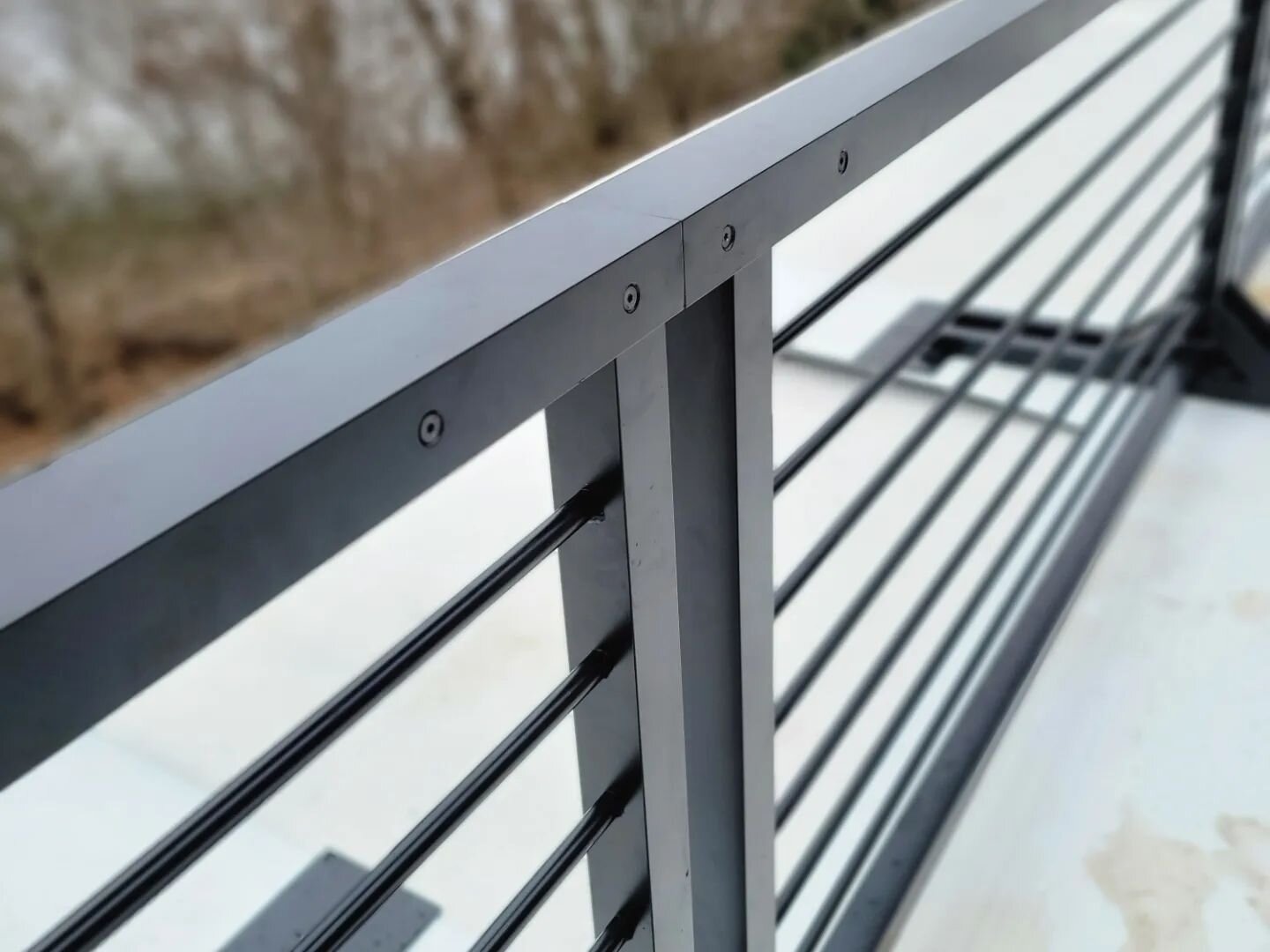 This &quot;floating&quot; aluminum terrace railing was fabricated and bolted together in 5 sections on site. We machined aluminum sleeves to prevent top rail deflection. Decking will cover the baseplates. 
 @jenniferradakovicdesign