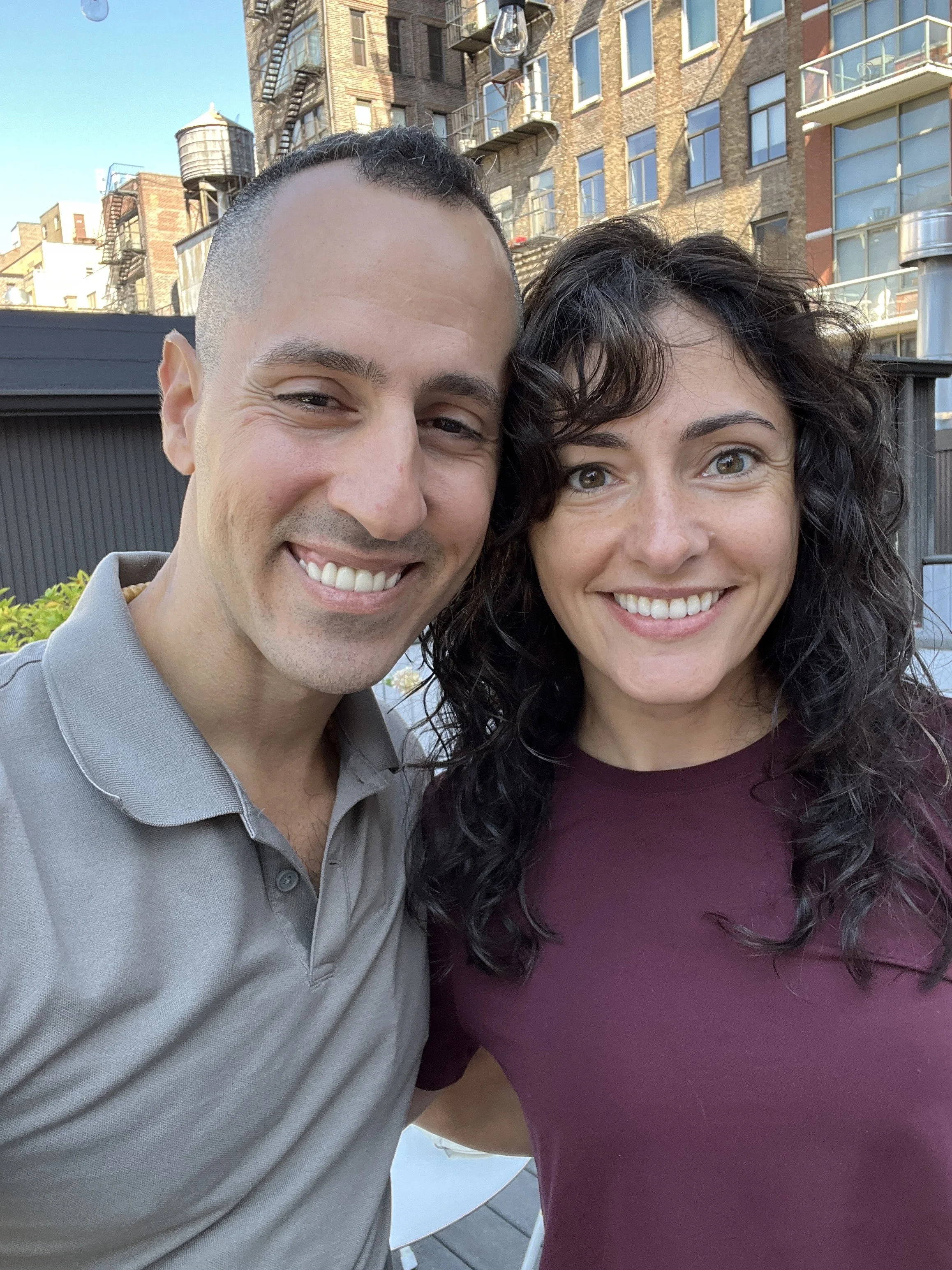 Jonathan Angelilli of Purestrength.nyc with one of his busy mom clients, smiling on the roof deck of the Complete Body gym in NYC.