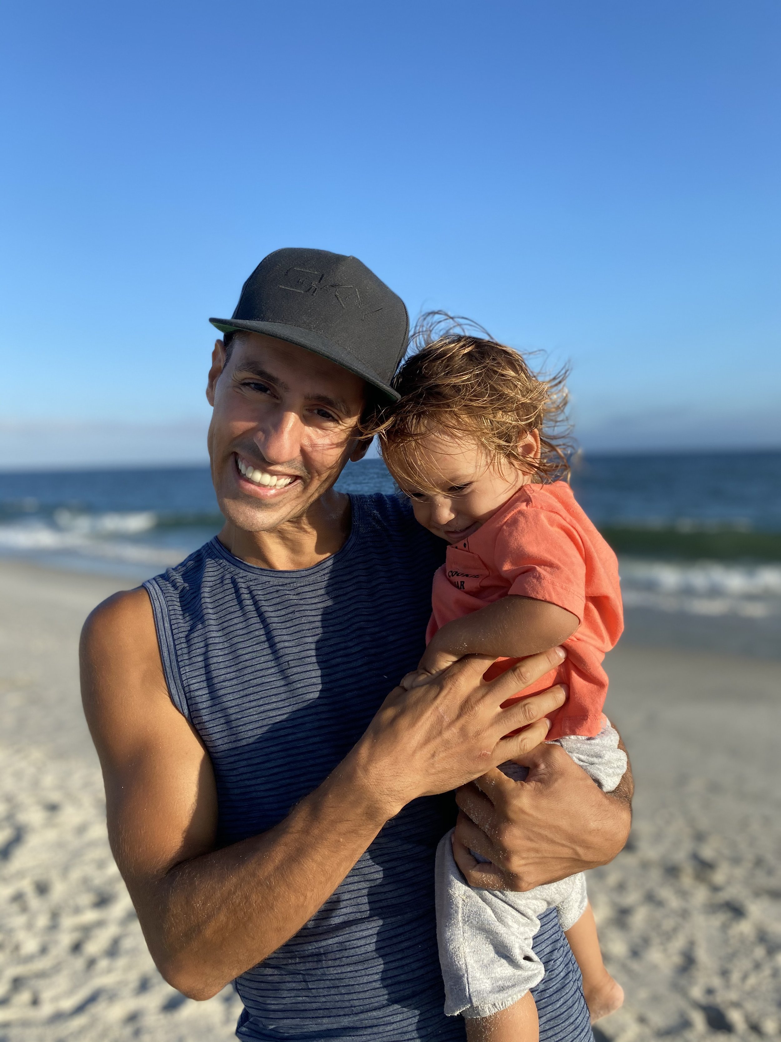 Jonathan on the beach with his son.