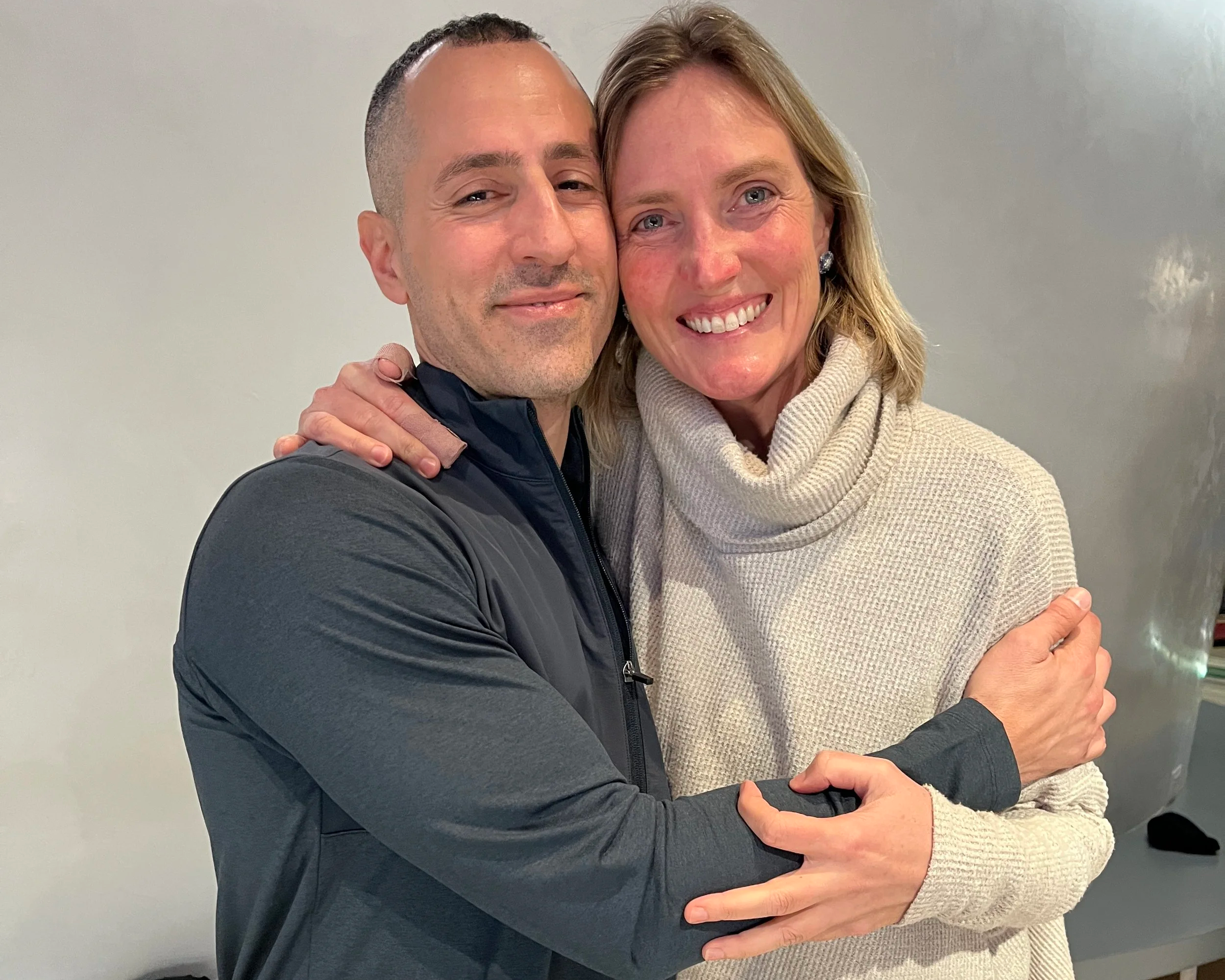 Jonathan Angelilli & Cassandra hugging at the gym after a Private Strength Training & nervous system coaching session.